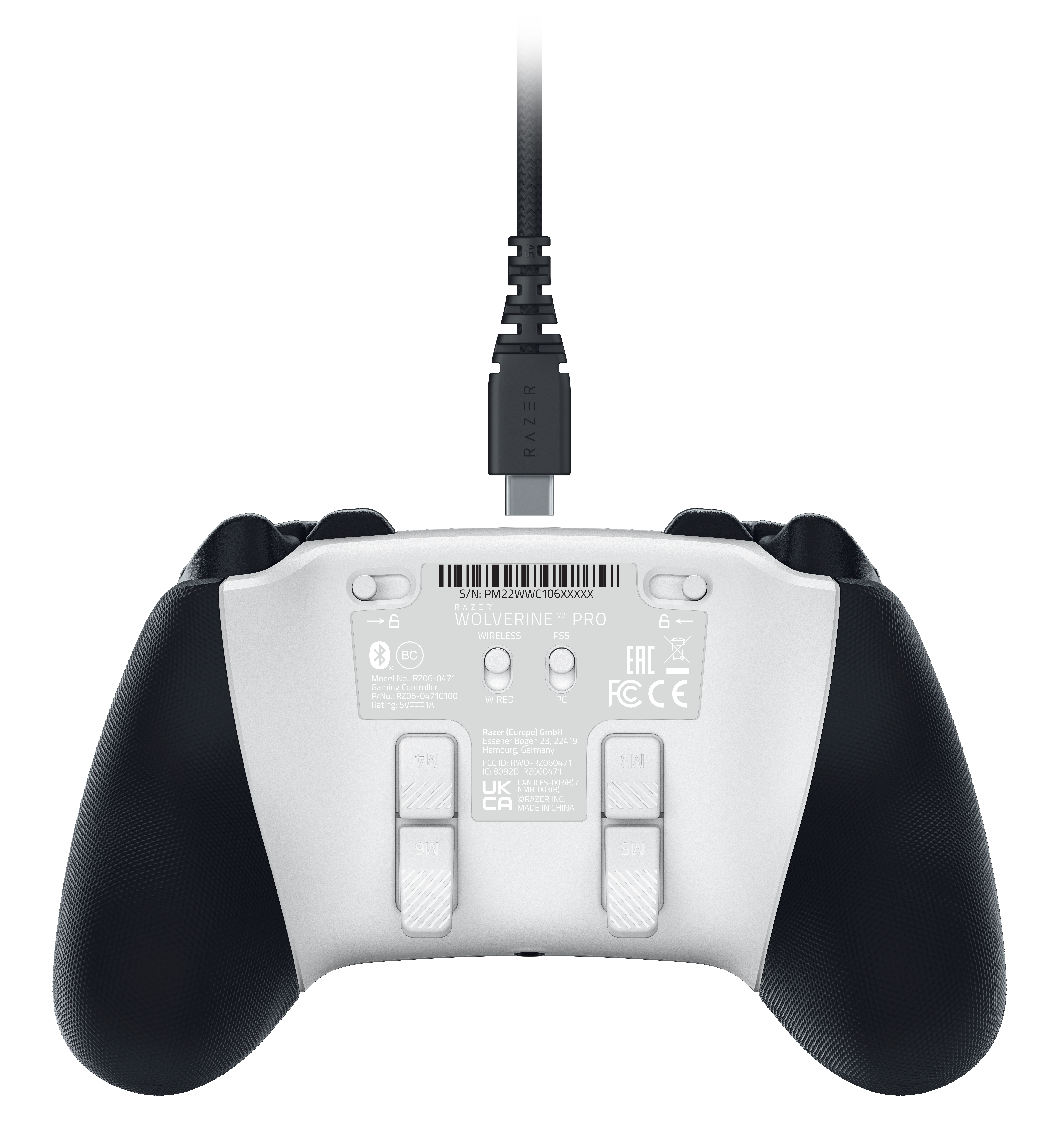 Back of a black and white game controller, with a charging cable.