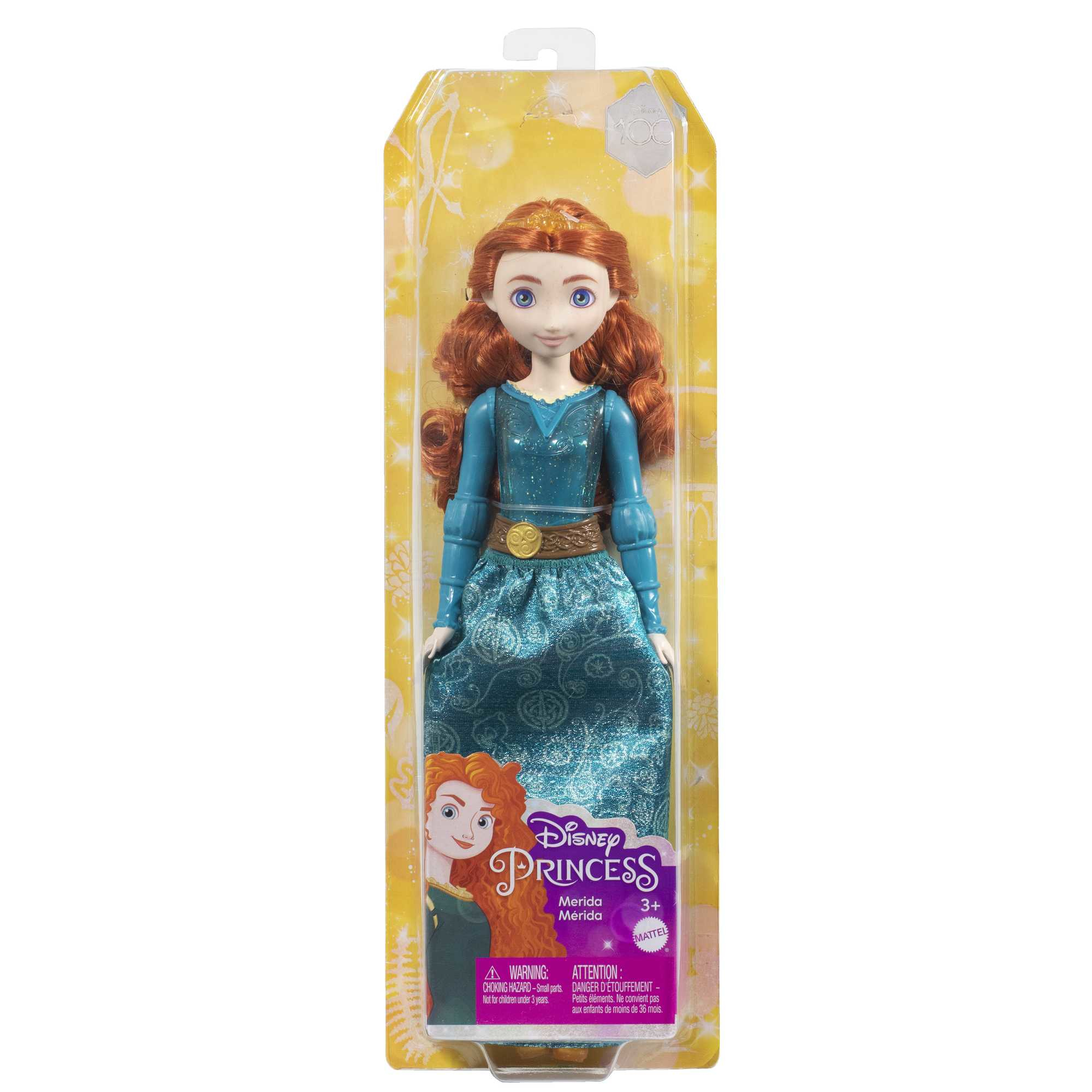 Lalka Disney Princess Merida w pudełku. Ma rude włosy i nosi niebieską sukienkę.