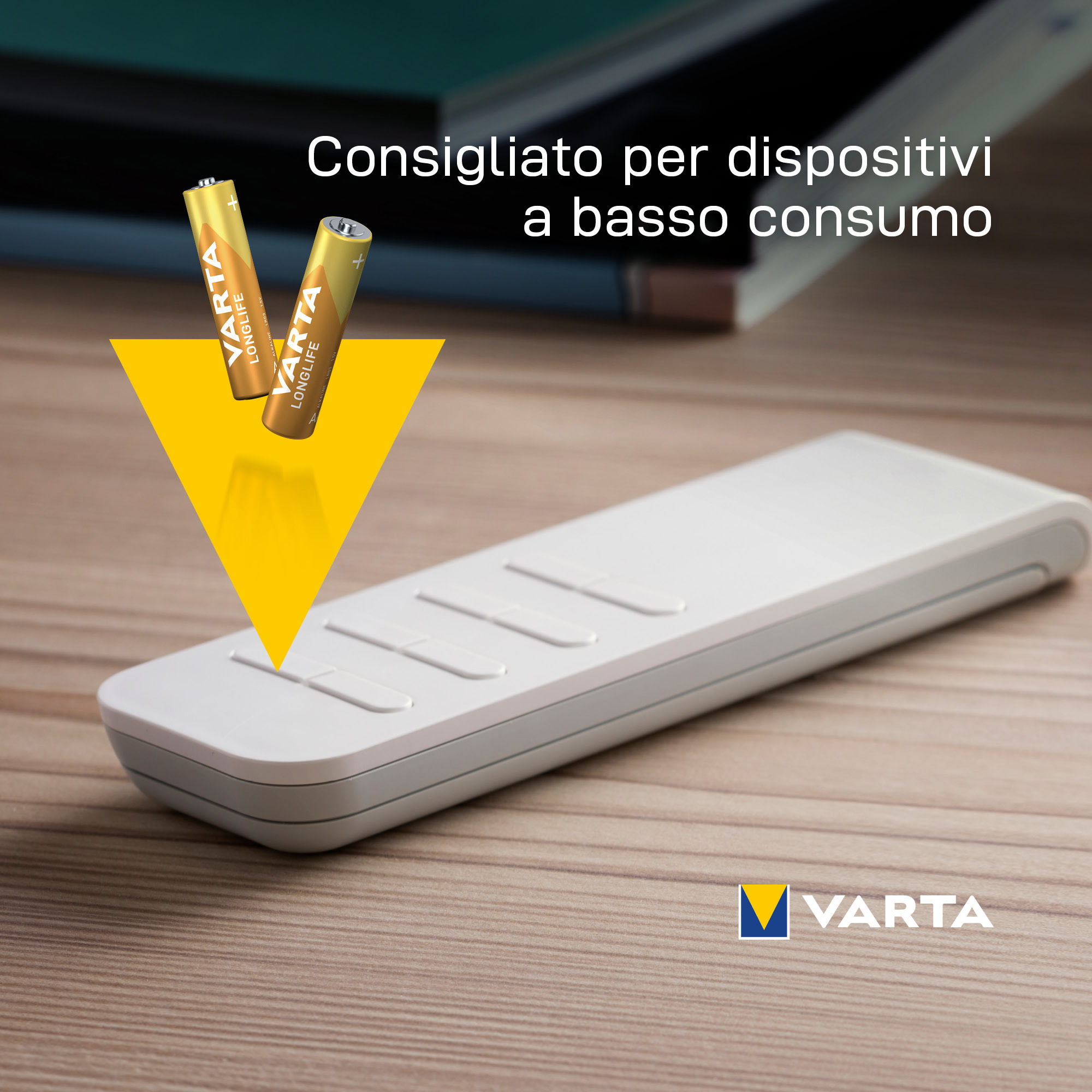 Two gold AA batteries and a white remote with text, with a yellow triangle pointing down.
