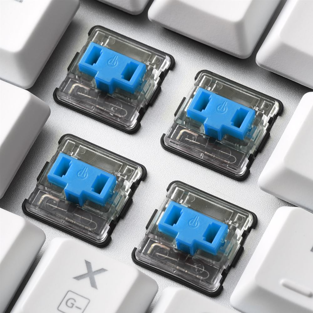 Four blue mechanical keyboard switches, close up. White keycaps surround the switches.