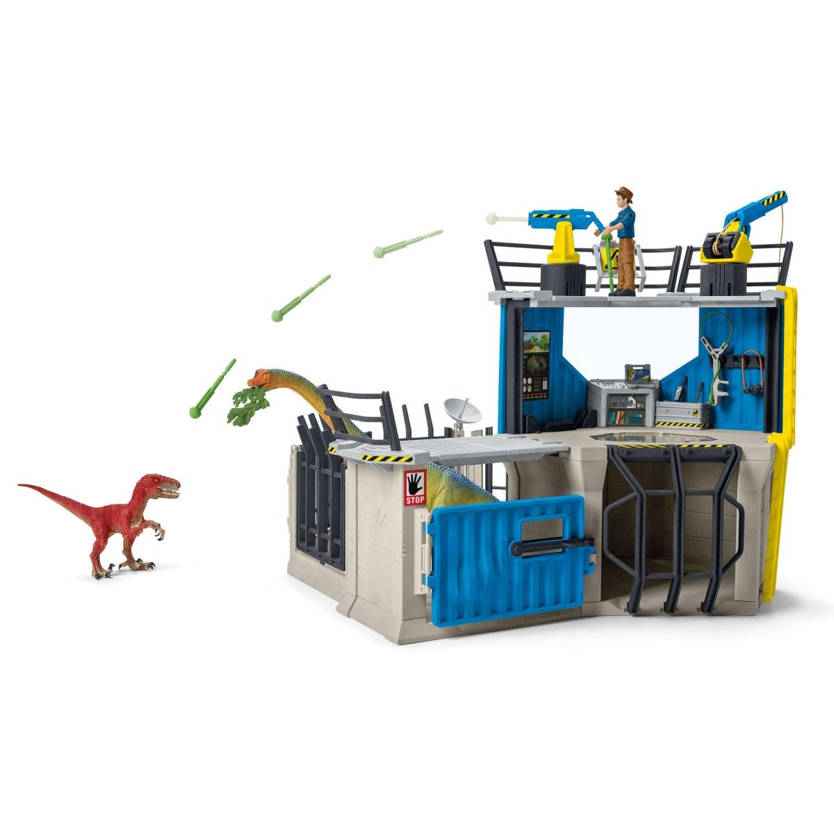 Ensemble de jouets dinosaures : Un dinosaure rouge attaque un bâtiment avec un homme dessus.