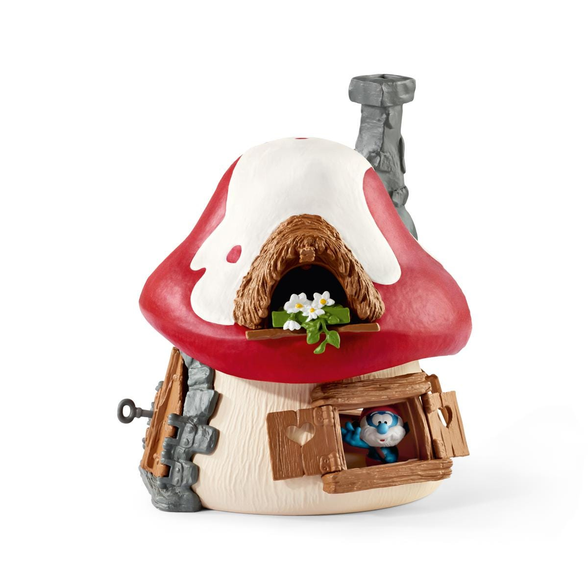 Un giocattolo a forma di casa dei Puffi con tetto a fungo rosso, finestra e un Puffo.