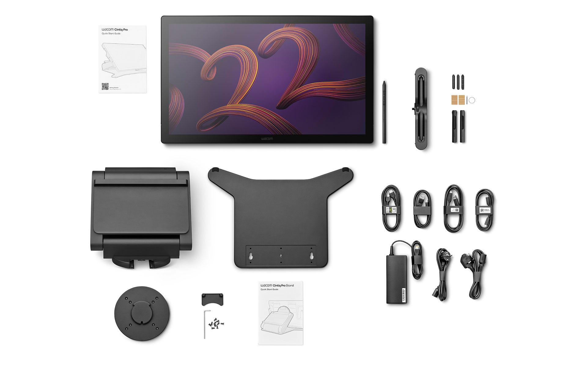 Widok z góry na tablet, pióro, podstawkę, kable i instrukcje szybkiego startu na białej powierzchni.