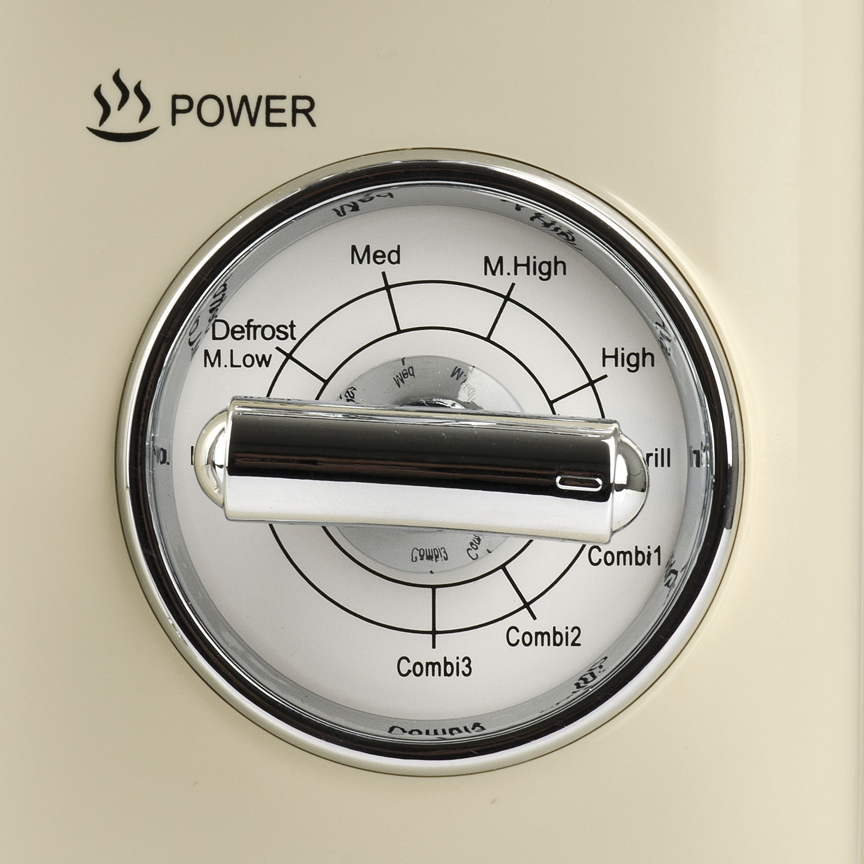 Kremowe pokrętło sterowania piekarnikiem, z ustawieniami: Rozmrażanie, Combi, Grill.