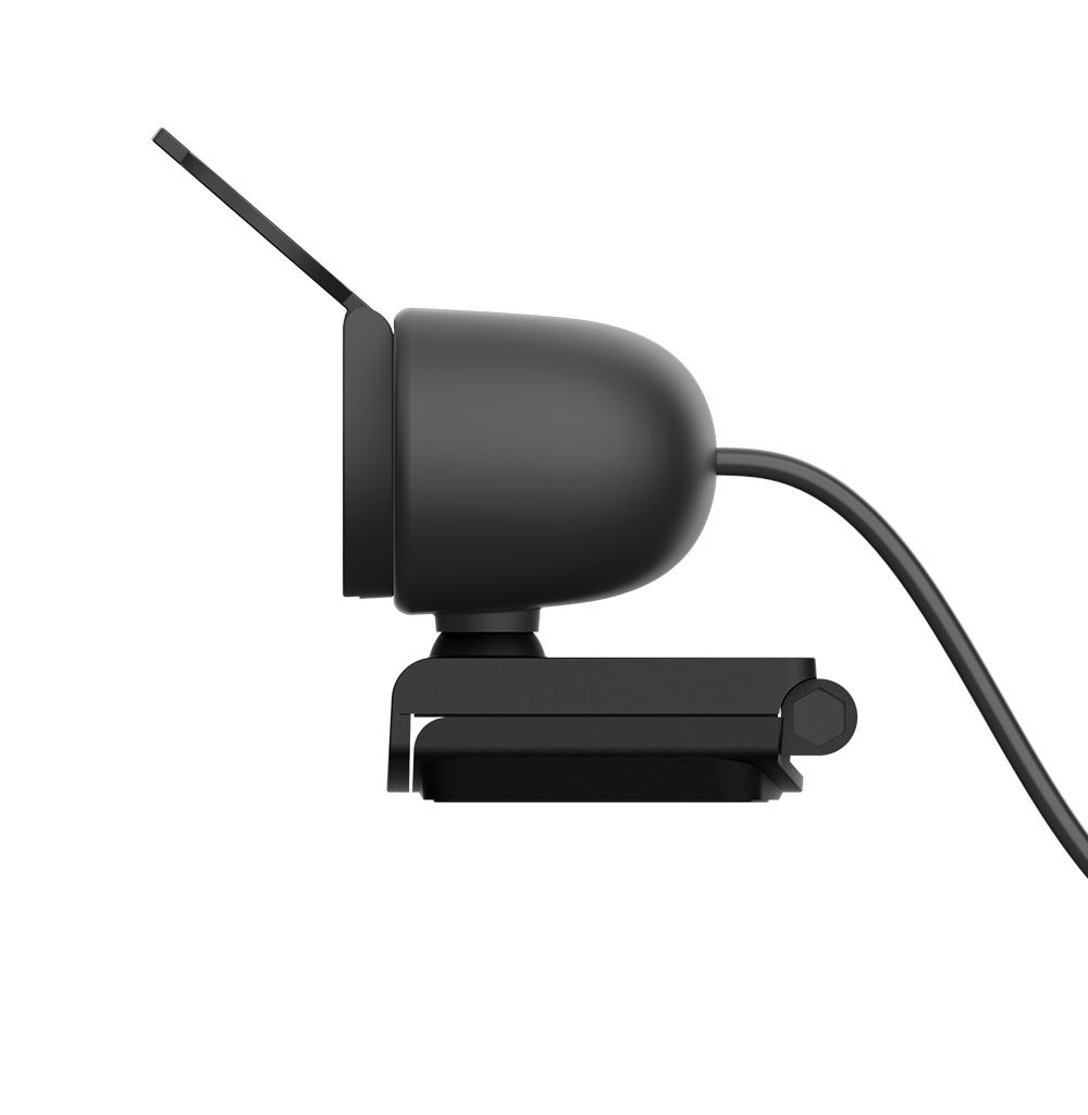 Side view of a black webcam. It has a camera, a clip, and a cable. Black background.