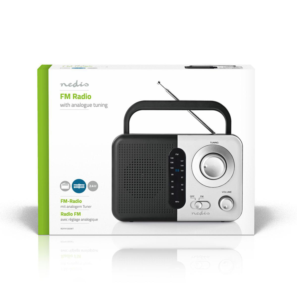 Ein neues UKW-Radio in seiner Box, schwarz-weißes Design, mit Griff und analoger Abstimmung.