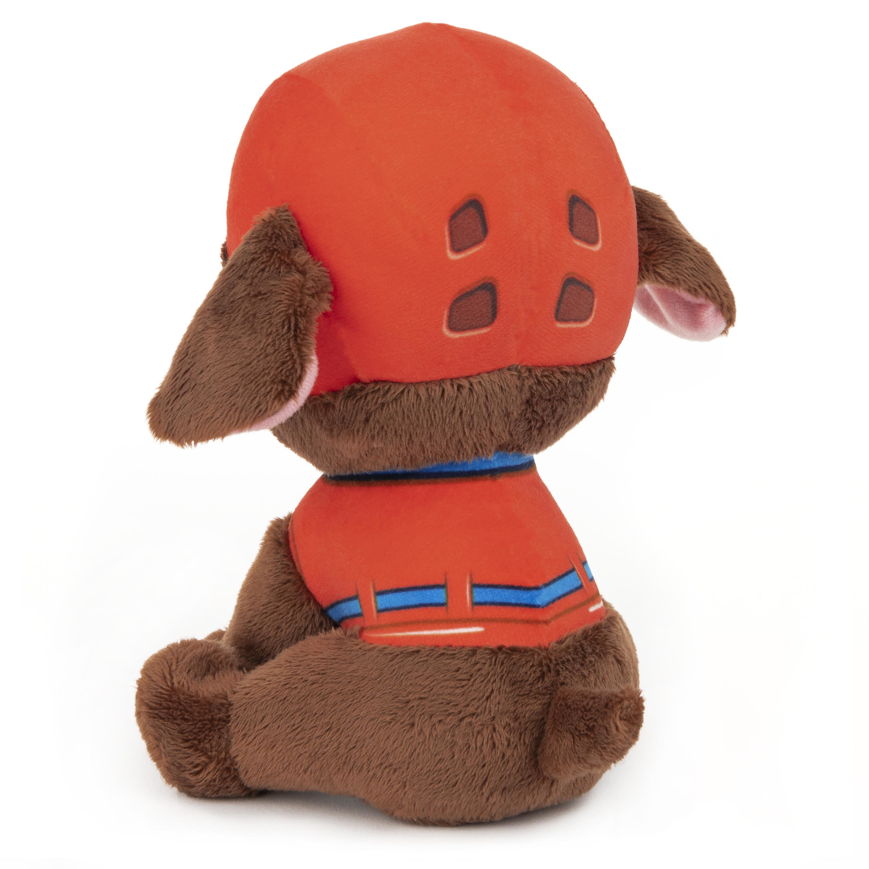 Braunes Hundespielzeug in roter Uniform, blauer Kragen, abgewandt.