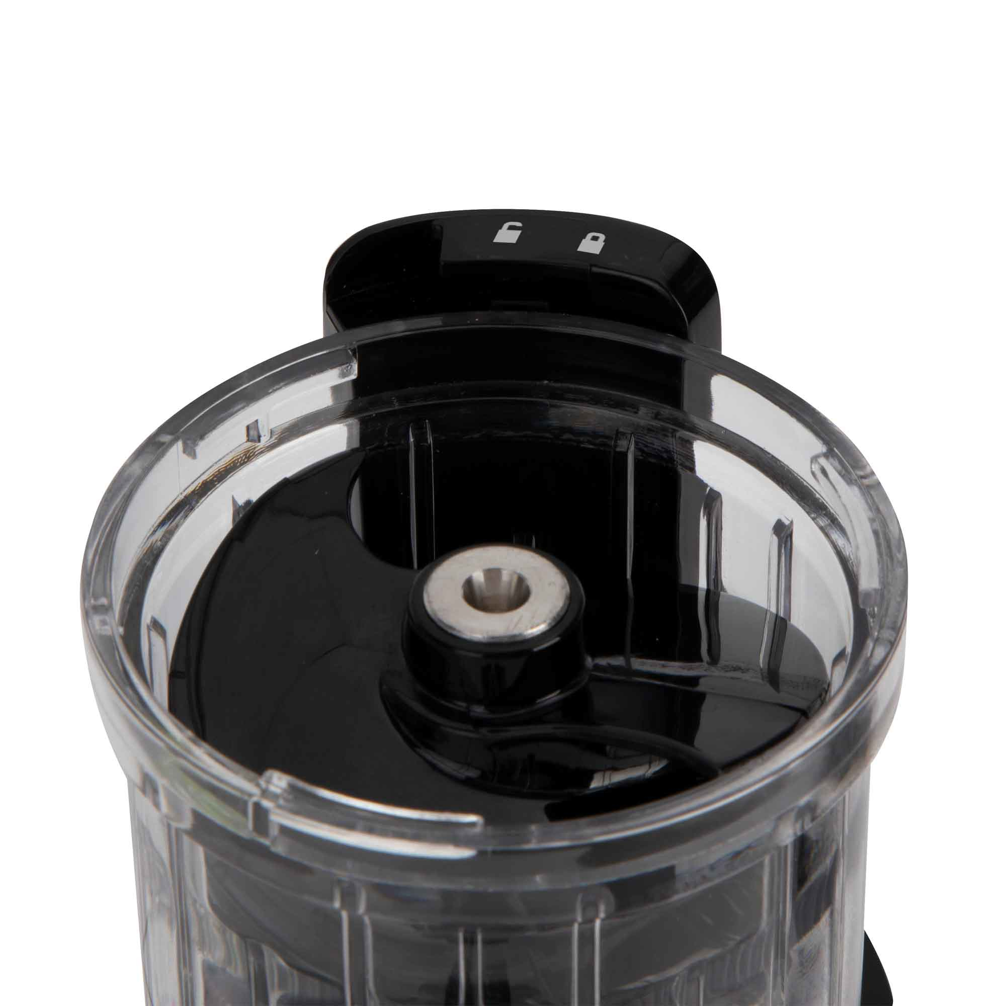 Primer plano de la parte superior transparente de un molinillo con interior negro.