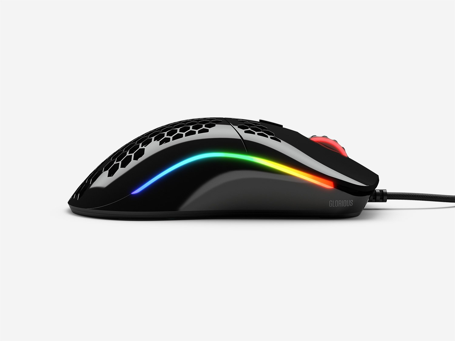 Black gaming mouse with honeycomb top and RGB lighting. The word "Glorious" is visible.