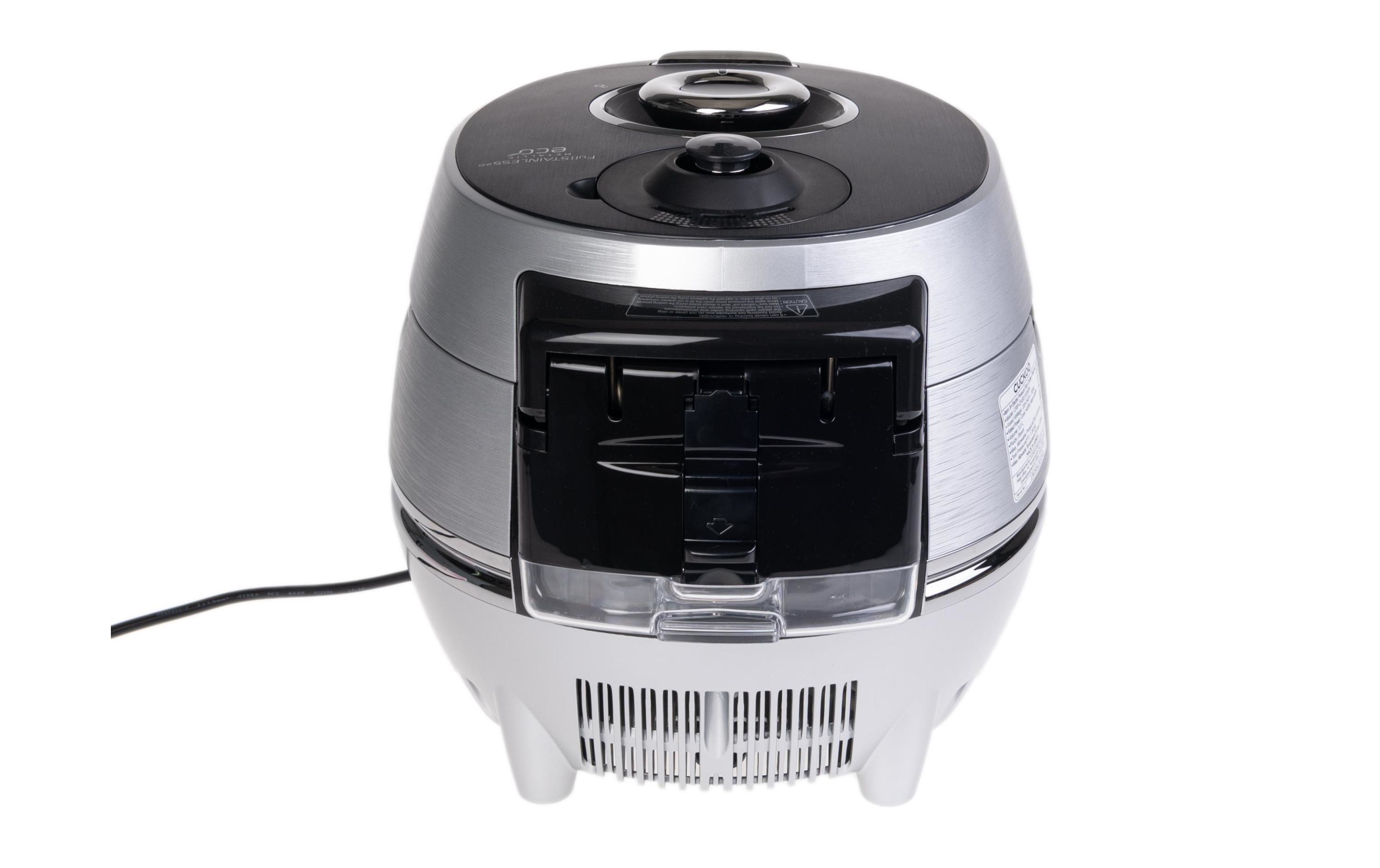 Srebrny i czarny garnek do gotowania ryżu na białej powierzchni.