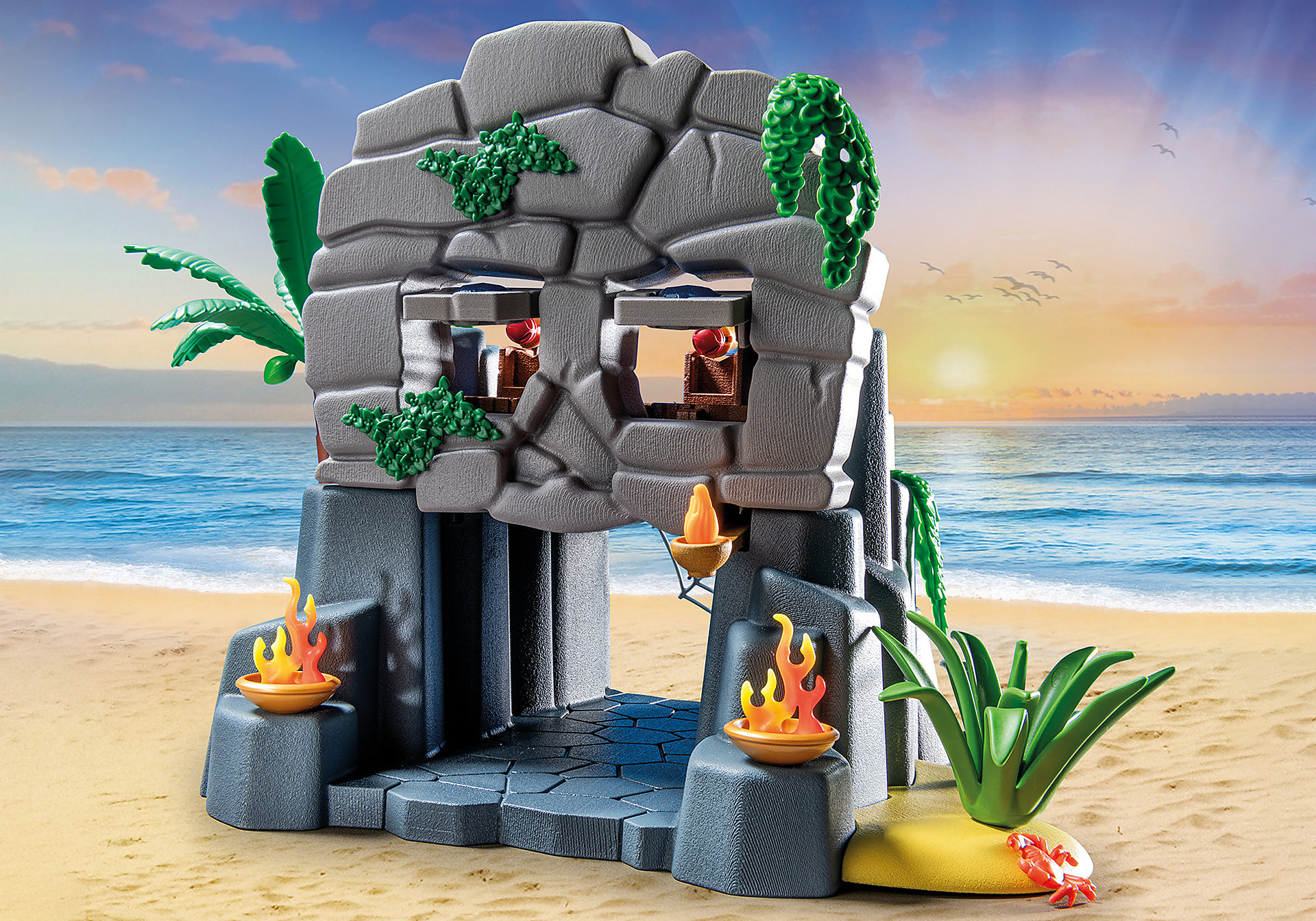 Ein Playmobil-Spielset mit einer Steinstruktur, Fackeln und einer sandigen Strandkulisse.