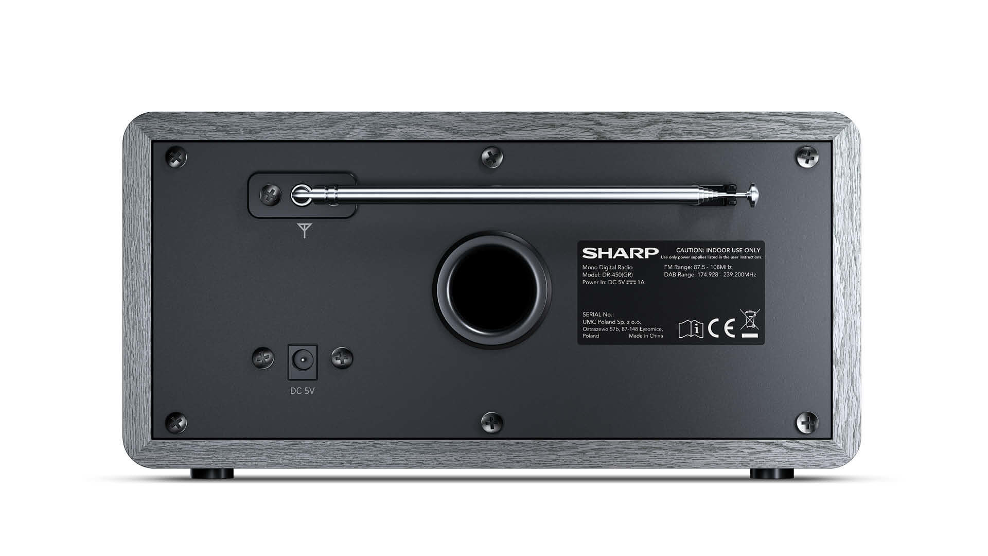 The back of a Sharp radio with a gray wood finish. It has a speaker, antenna, and various ports.