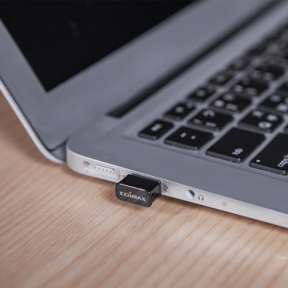 A black USB adapter plugged into a laptop, showing the 'EDIMAX' brand.