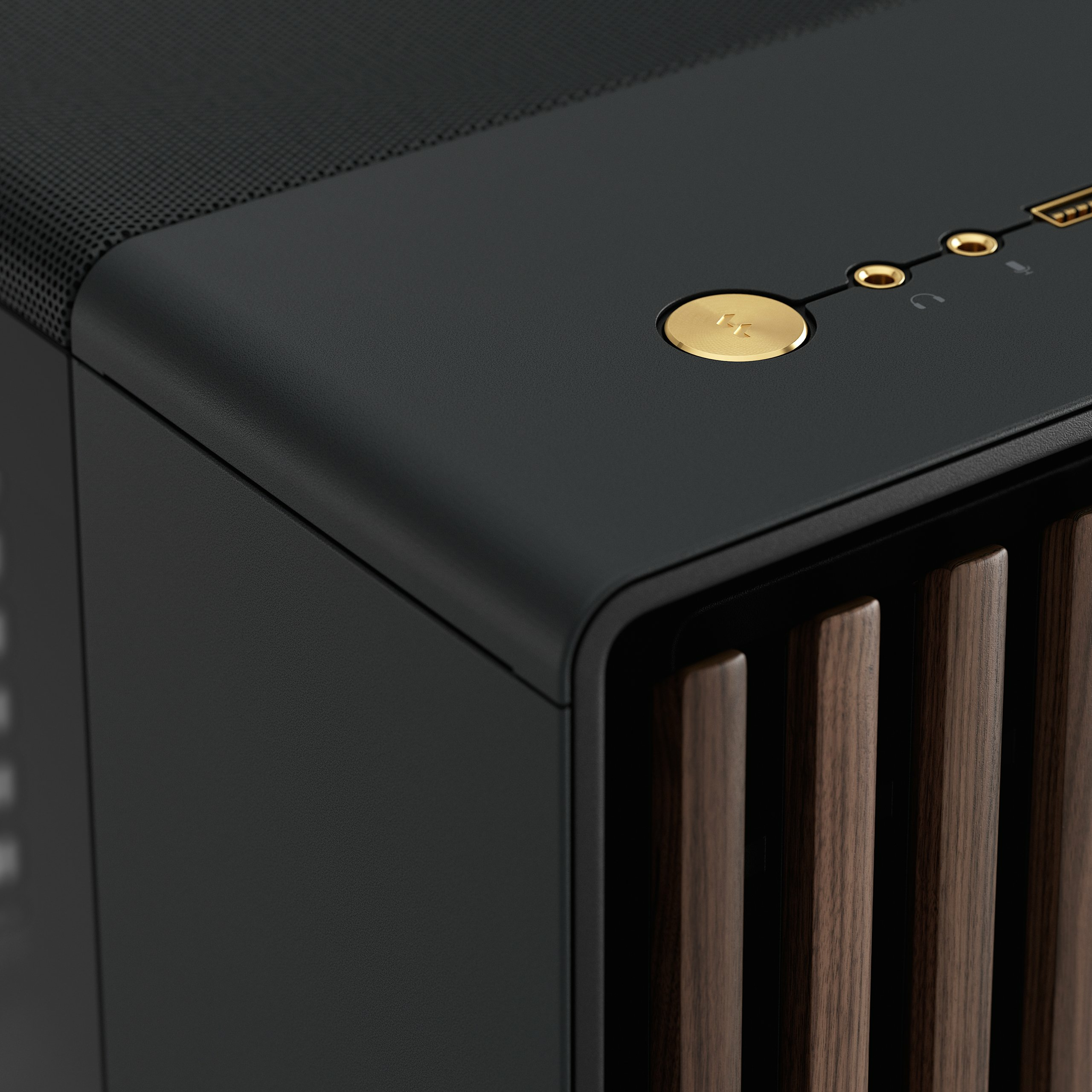 Close-up of a black PC case. It has a gold button and connection ports.