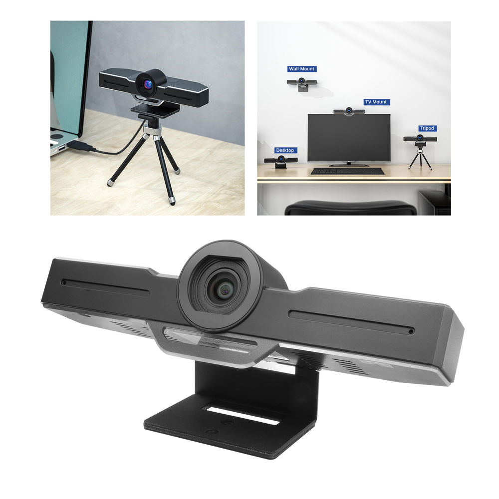 Webcam auf Stativ, Schreibtisch und Wand. Die Webcam hat ein schwarzes Gehäuse mit Linse.