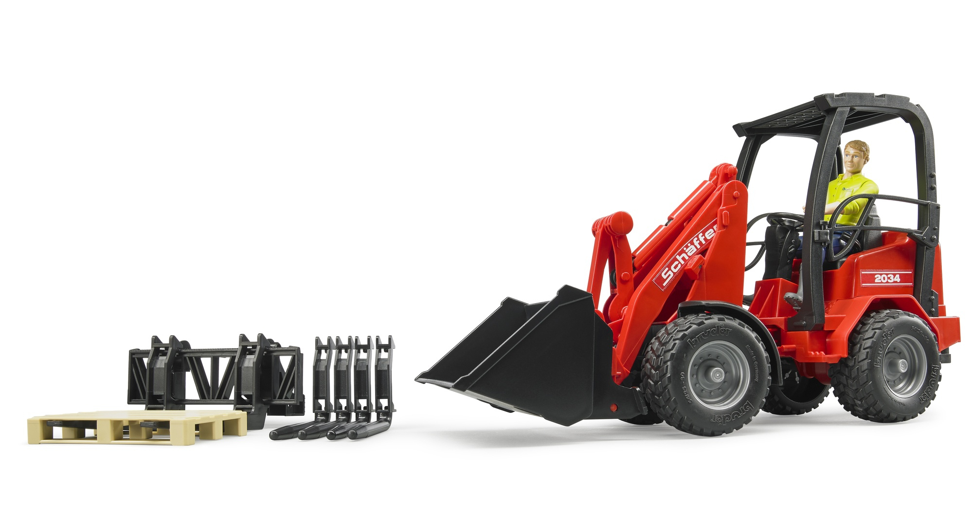 Czerwony zabawkowy pojazd budowlany z czarną łyżką i widłami, obok palet.