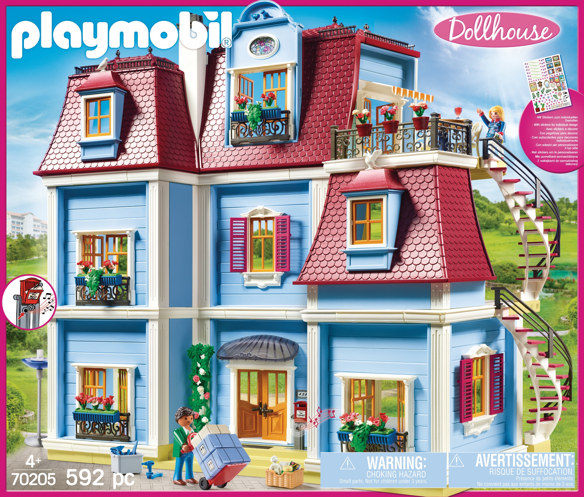 Domek dla lalek Playmobil z wieloma piętrami, balkonami i kręconymi schodami. Mężczyzna trzyma pudełko.