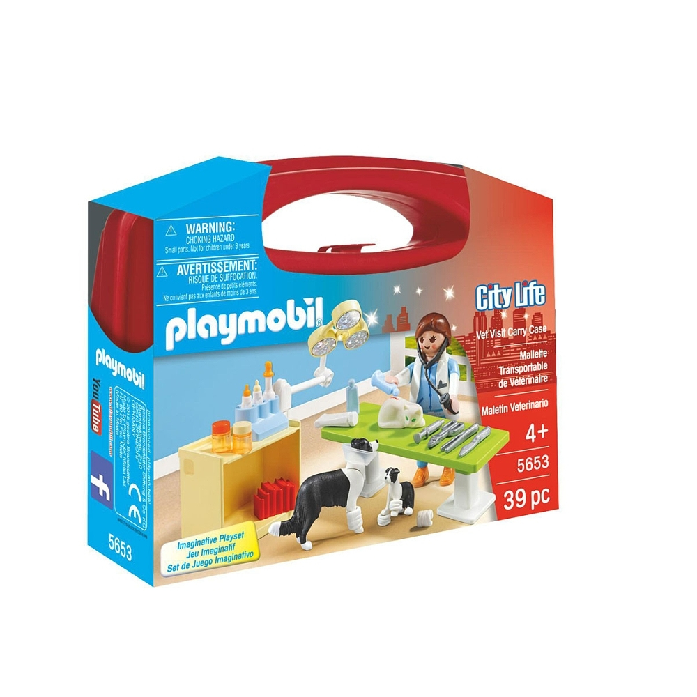 Scatola del set Playmobil. Un veterinario, cani e strumenti medici sono su un tavolo all'interno della scatola.