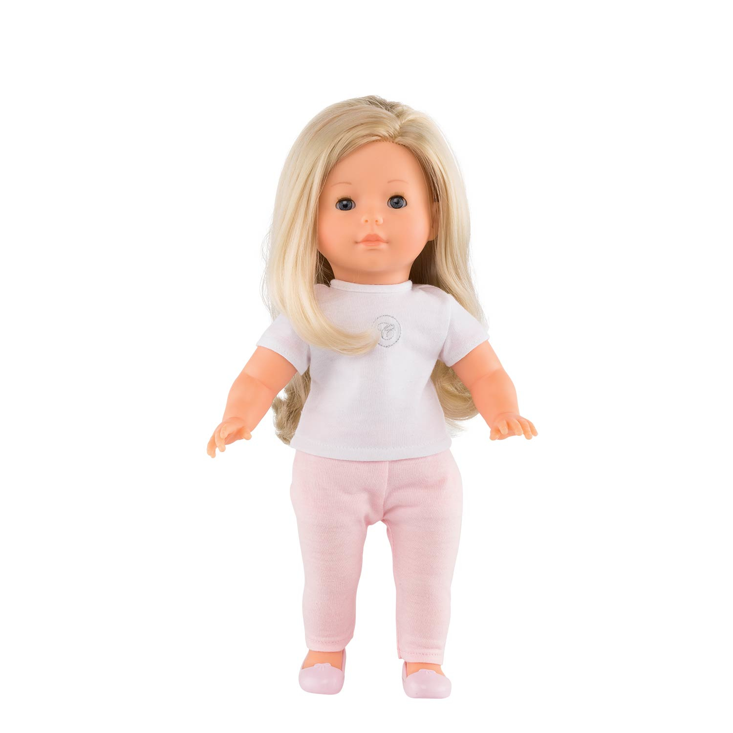 Blondynka w białej koszuli i różowych spodniach. Lalka stoi i patrzy w przód.