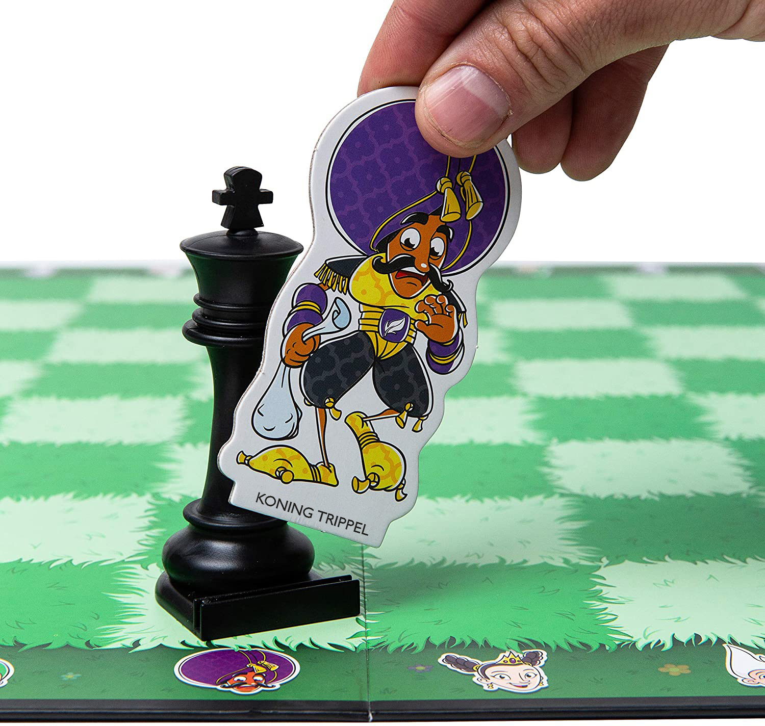 Una mano che tiene un pezzo di gioco accanto a un pezzo di scacchi nero e una scacchiera verde.