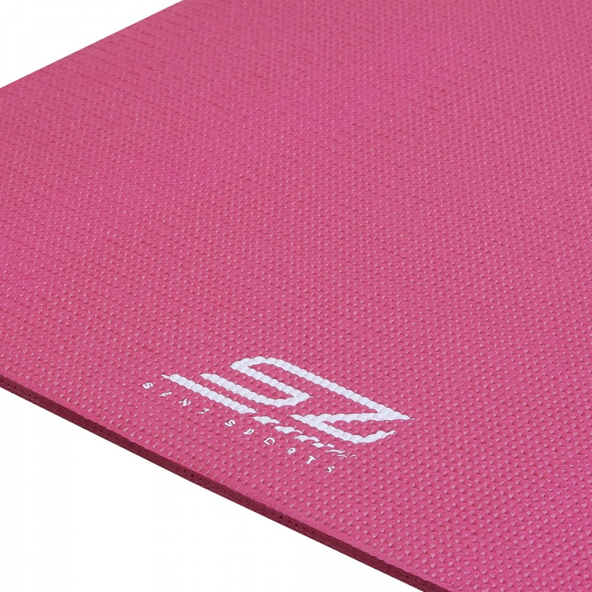 Pink yoga mat with white logo. Textured surface, folded at an angle.