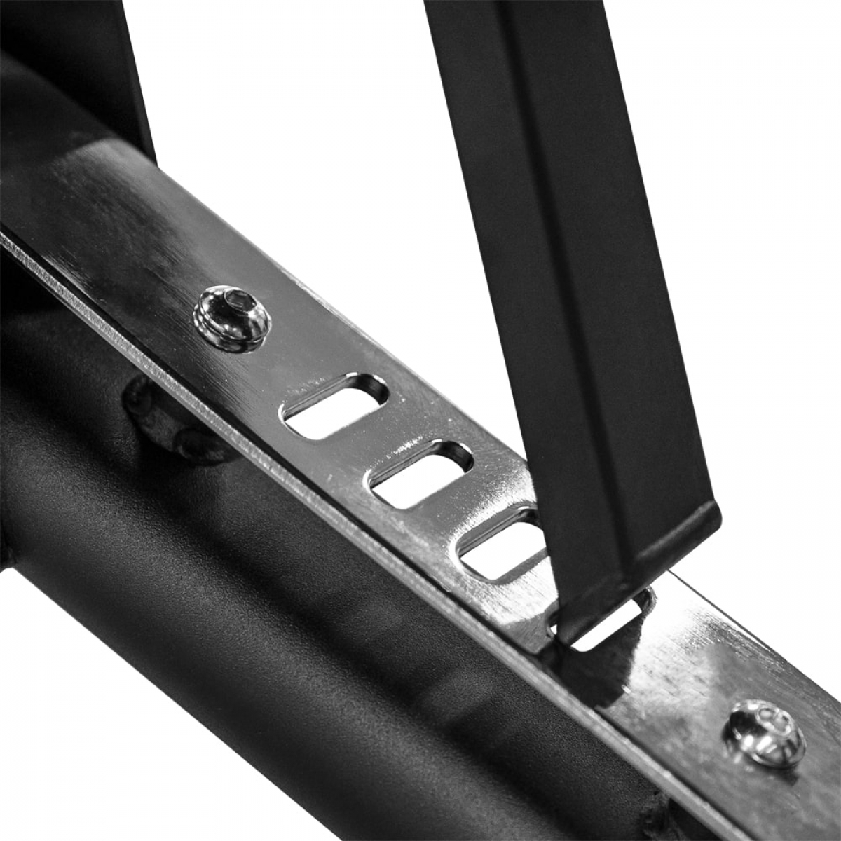 Close up of metal brackets. The brackets are black and silver with screws, bolted to a black frame.