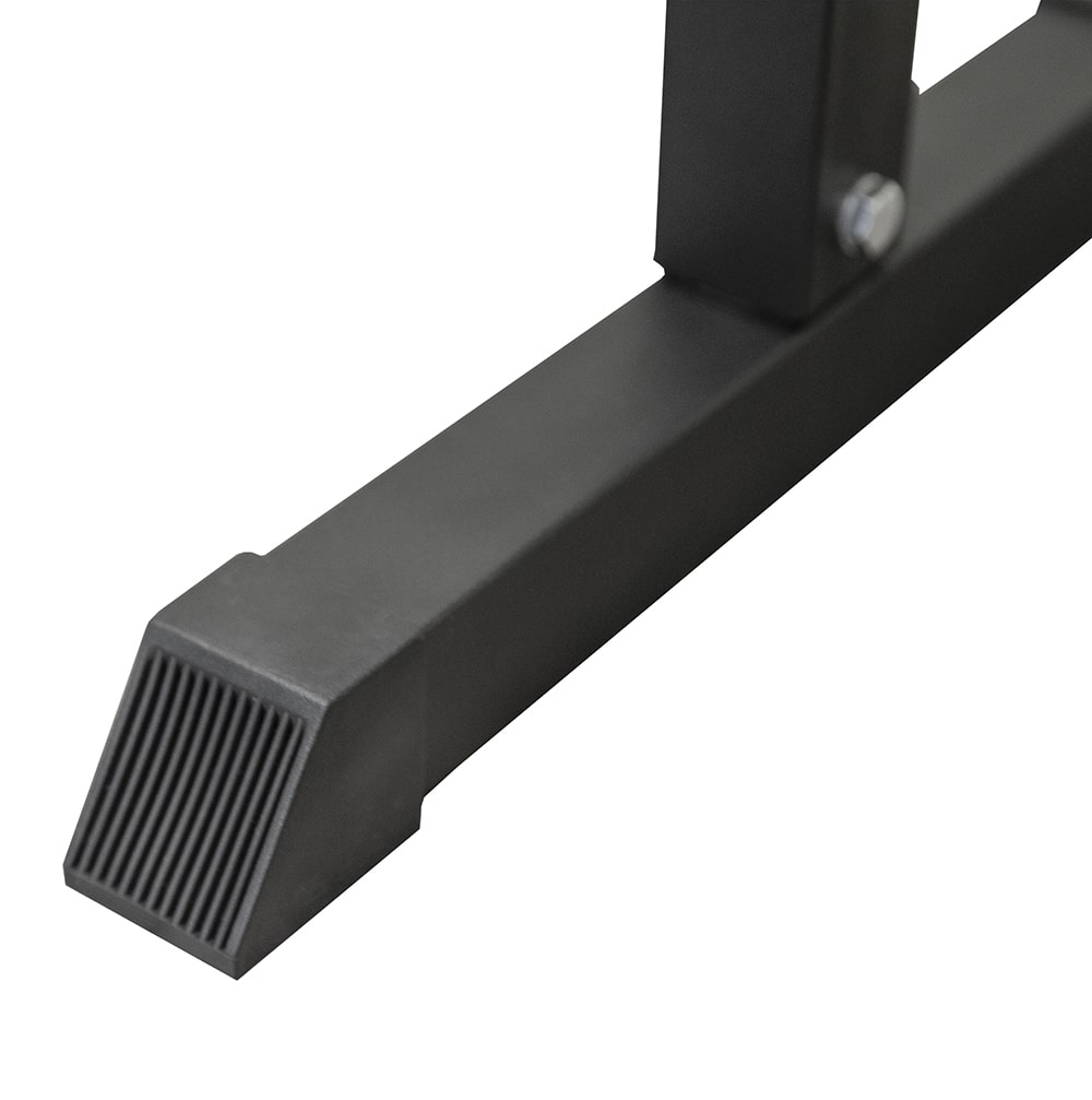 The black base of an exercise bench with a ribbed rubber foot, white backdrop.