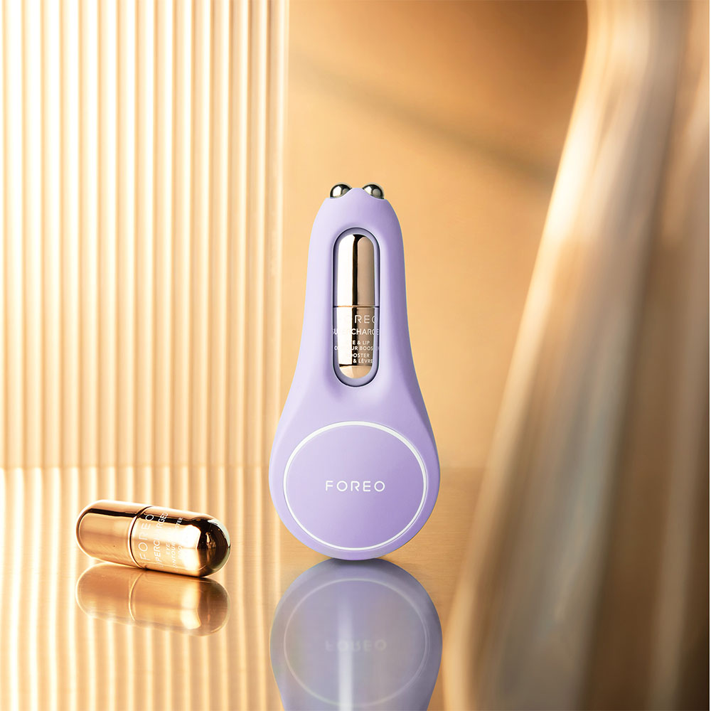 Purple facial device with a golden capsule. The device has a light purple color.