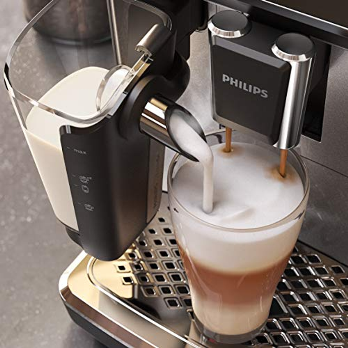Philips kahve makinesi, bardağa süt dökülüyor. Latte sanatı görünür. Gri arka plan.