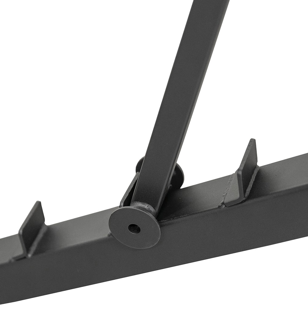 A close-up of a black metal frame with a connecting joint and support.