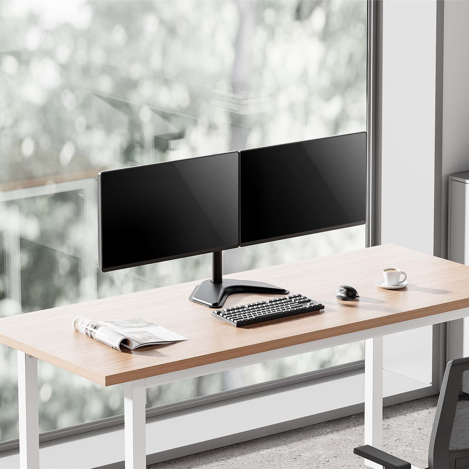 Una configuración de escritorio con dos monitores negros, teclado, ratón y una taza de café, cerca de una ventana.