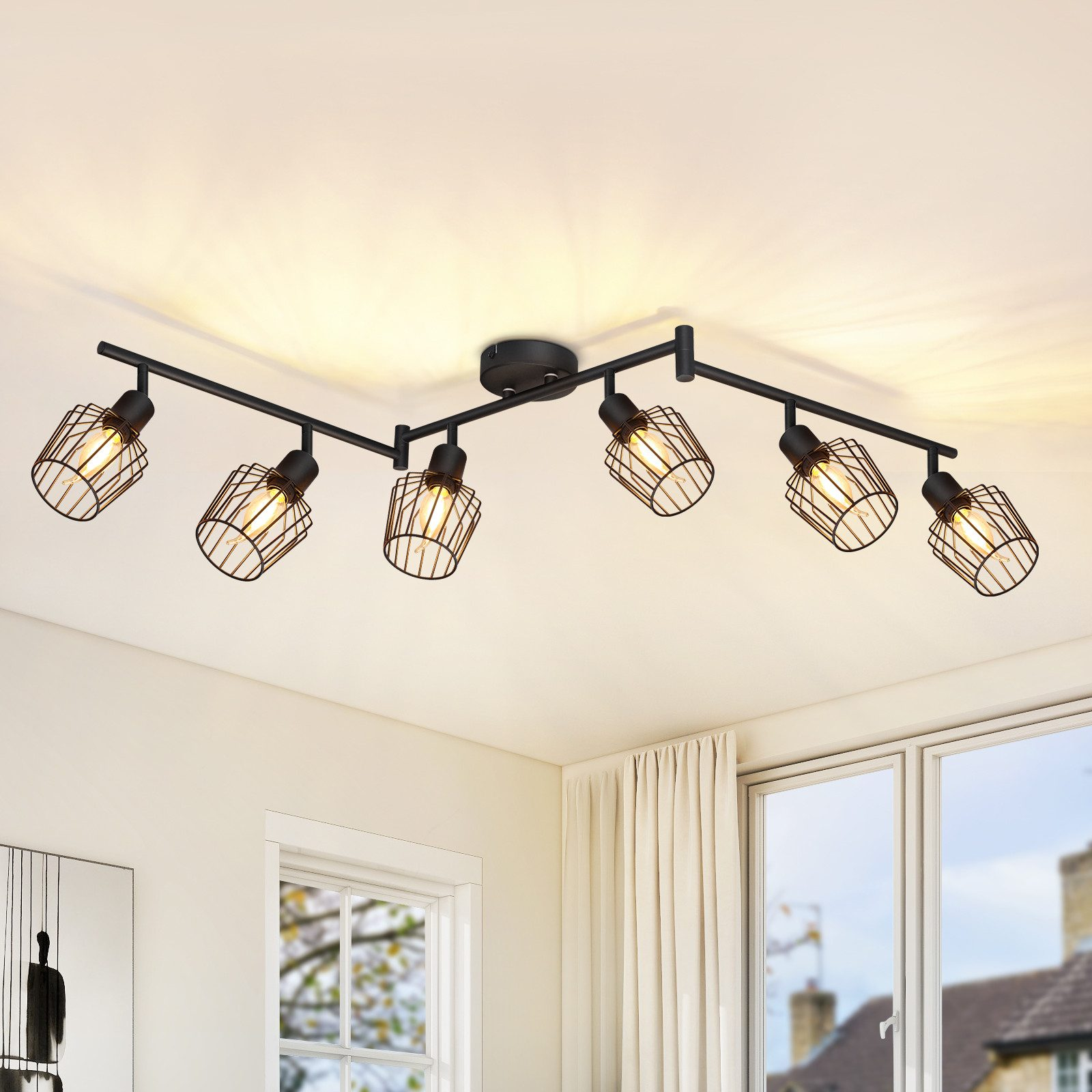 Reflektory sufitowe we wnętrzu w nowoczesnym stylu. Są czarne z klatkowymi światłami.