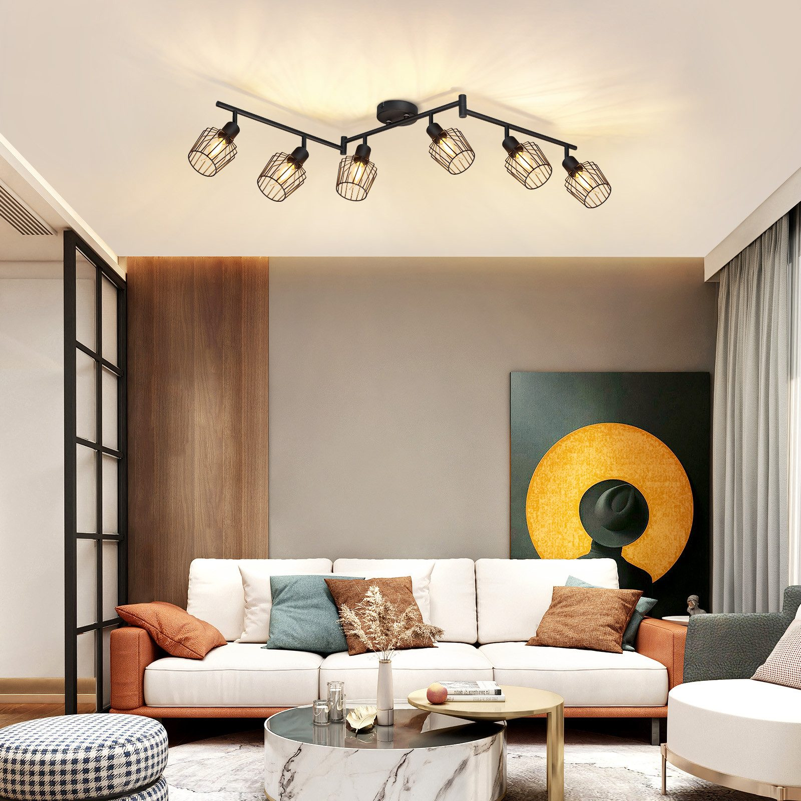 Nowoczesny salon z oświetleniem sufitowym, sofą i obrazem na ścianie.