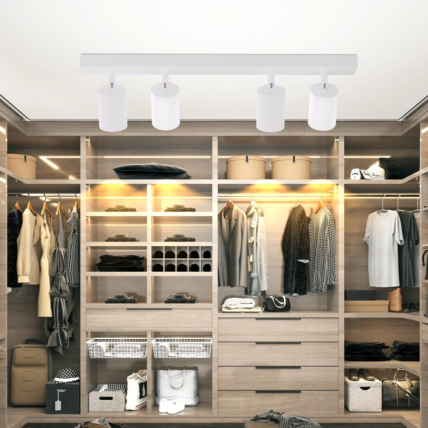Armadio con vestiti e un sistema di illuminazione a binario bianco con quattro luci.