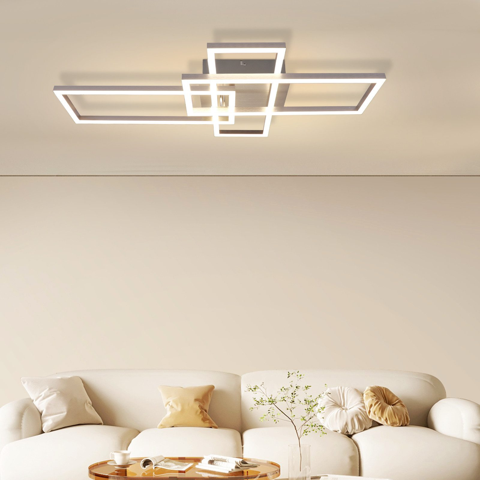 Lampada da soffitto bianca moderna con forme geometriche, montata su soffitto neutro.