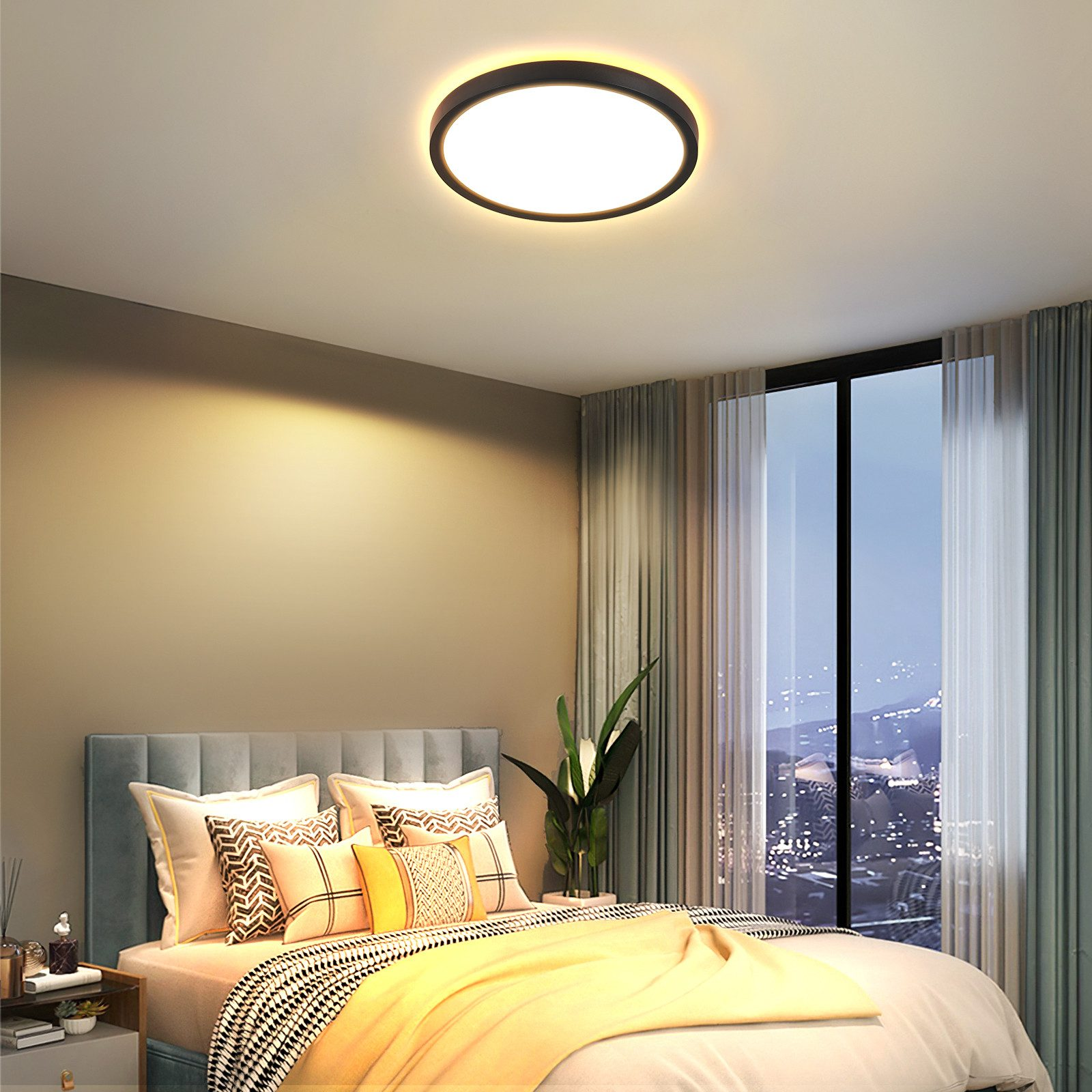 Plafoniera rotonda in camera da letto. Finestra con vista sulla città. Letto con cuscini e coperta.
