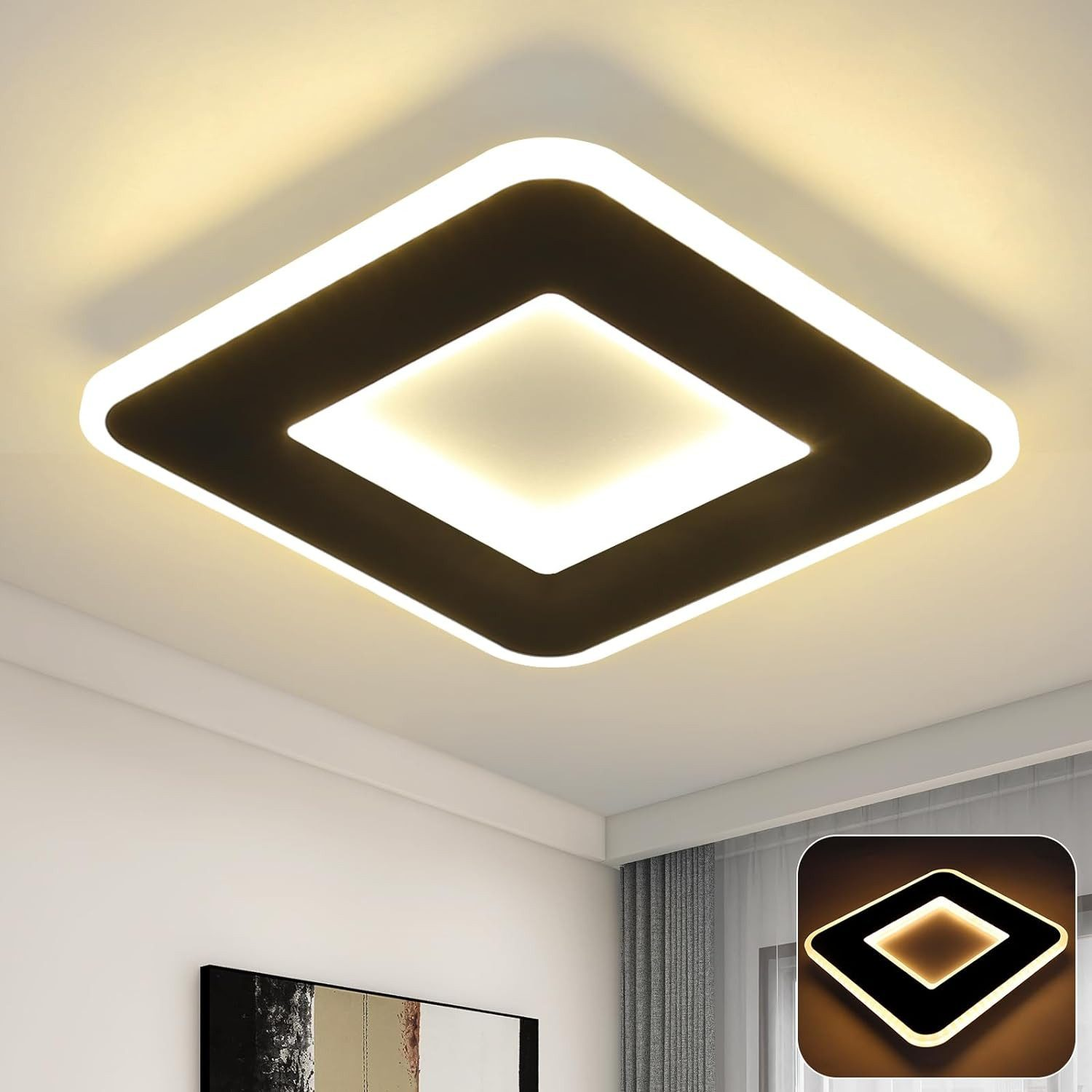Un apparecchio di illuminazione quadrato con cornice nera e centro bianco, montato su un soffitto bianco.