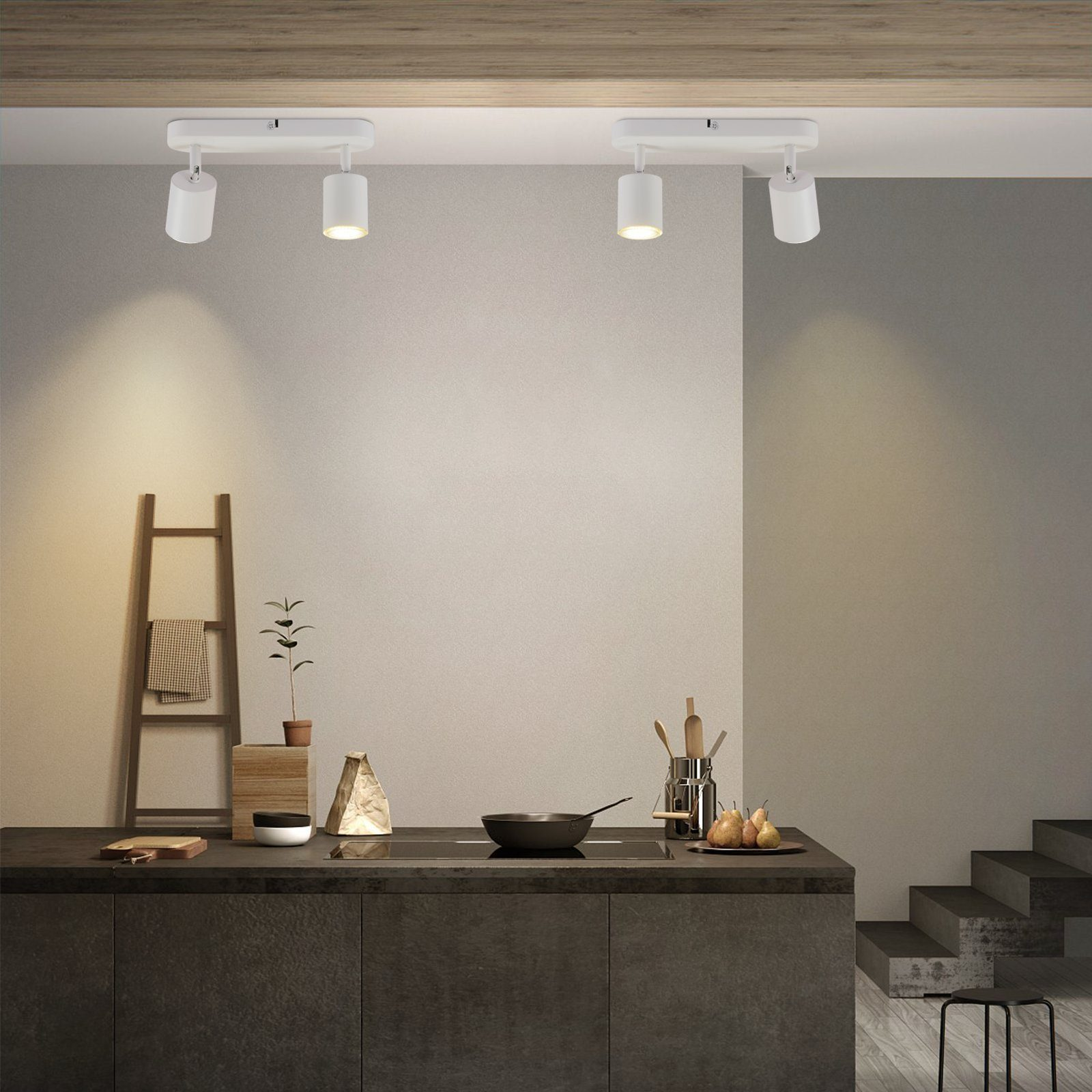 Cucina con due faretti bianchi. Sono visibili anche una scala di legno, piante e utensili da cucina.