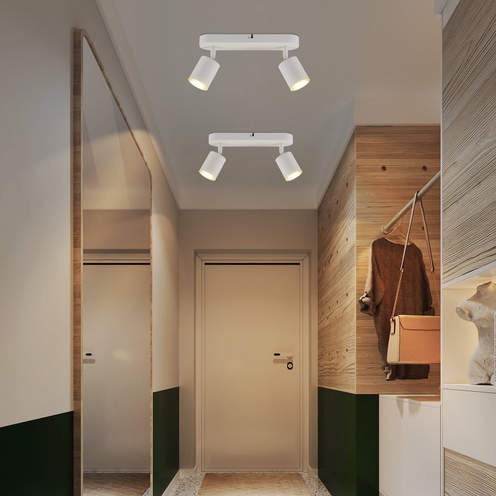 Due faretti bianchi su un soffitto bianco. I faretti illuminano un corridoio.