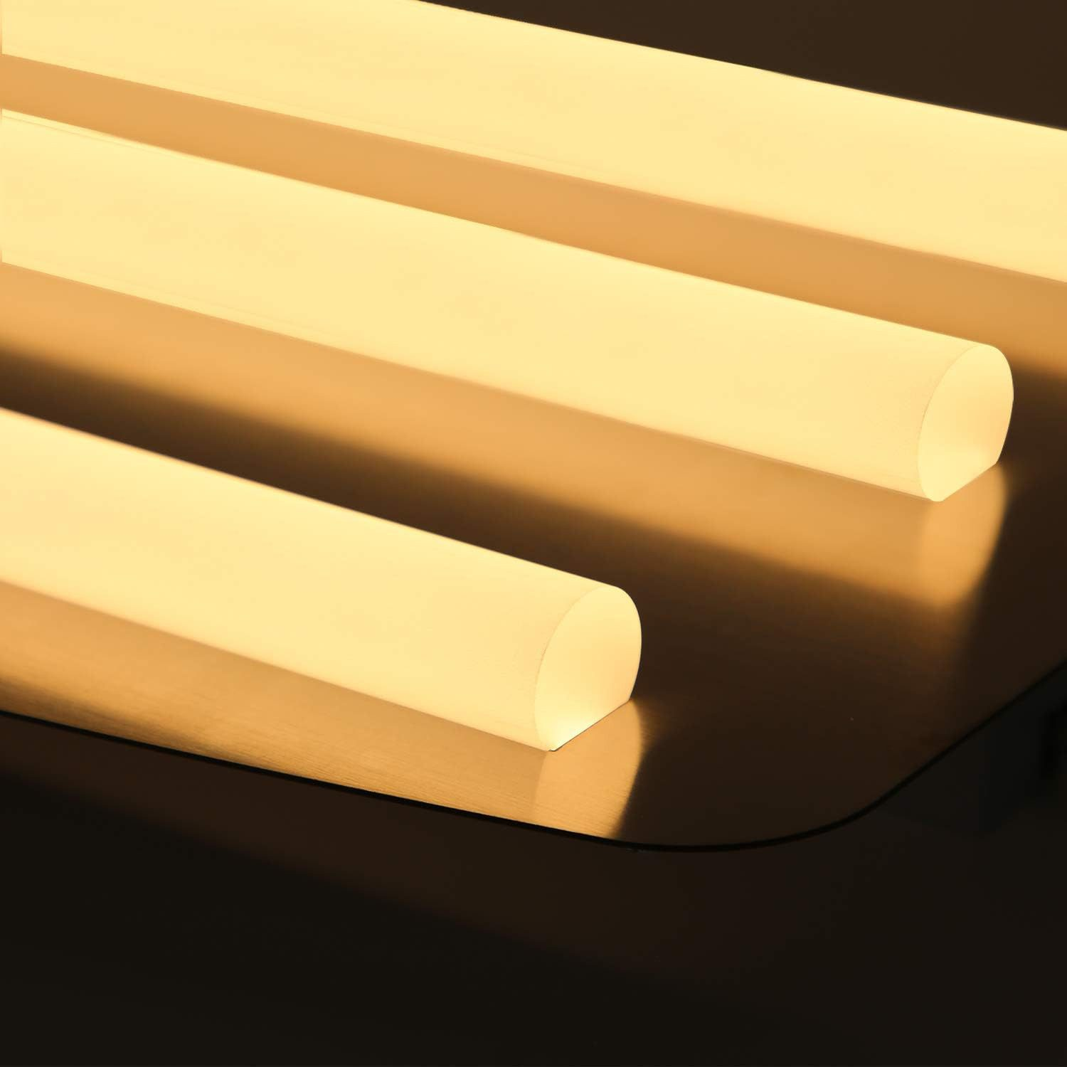 Primo piano di tre barre luminose illuminate. Sfondo scuro.