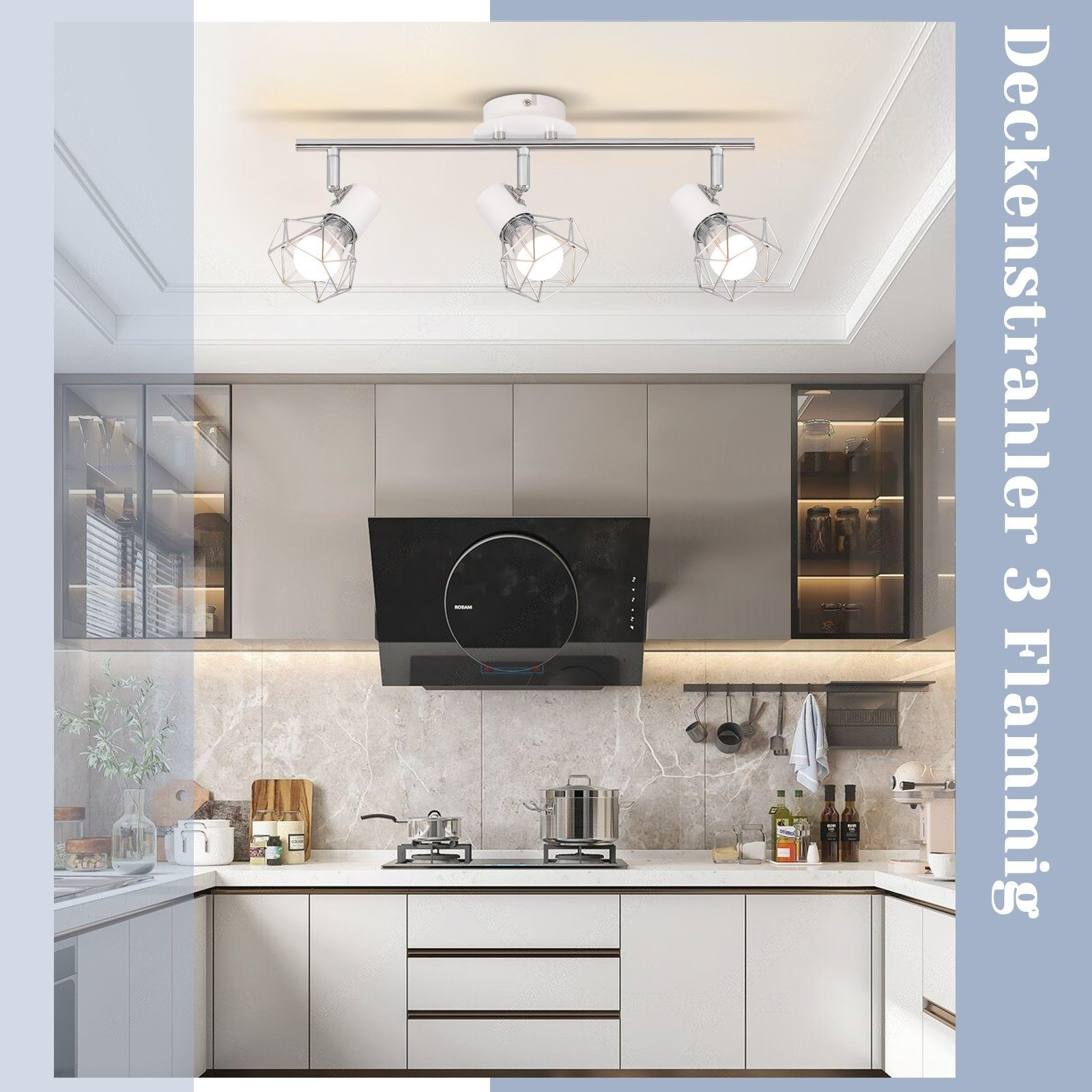 Cucina con faretti a soffitto. Sono visibili mobili, piano di lavoro in marmo e cappa aspirante.