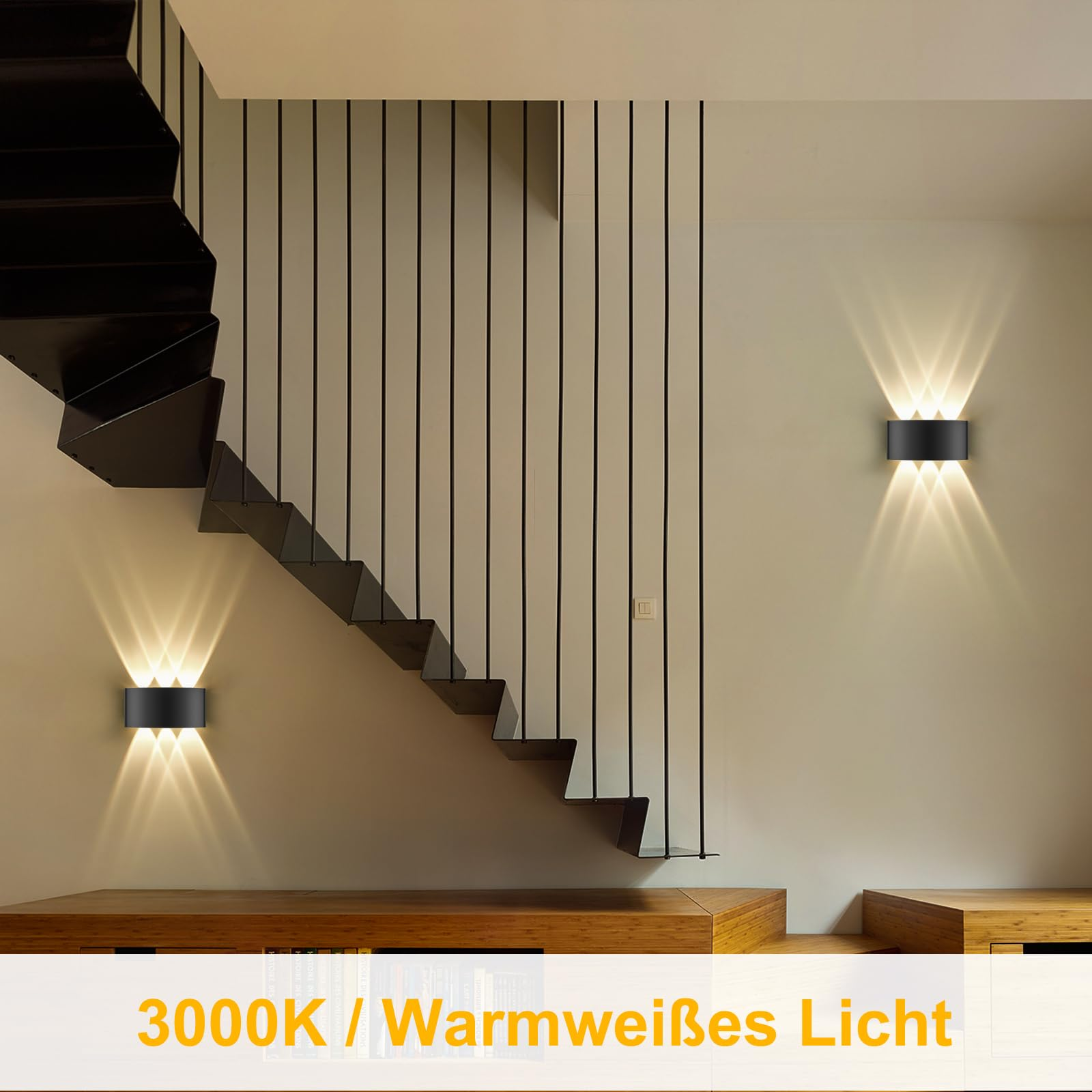 Treppenhaus mit schwarzen Wandleuchten, Treppe und Holzbank. Warmweißes Licht.