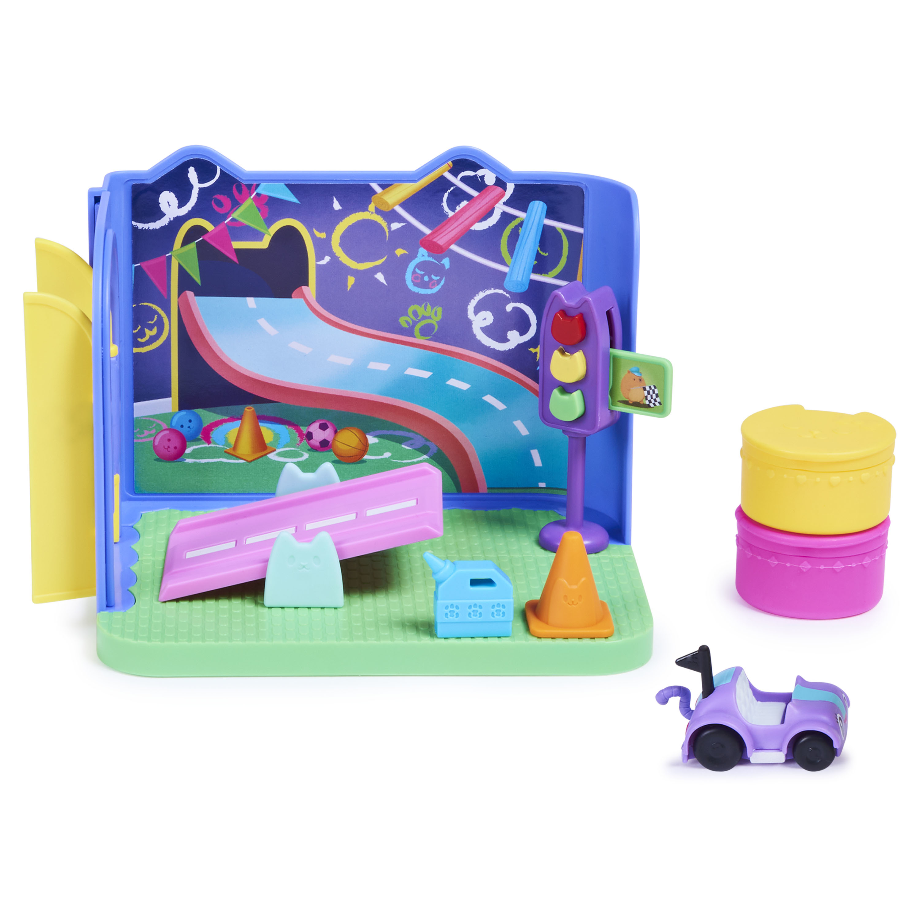 Ein Spielzeug-Spielset mit einer Rennstrecke, einem Auto und verschiedenen Zubehörteilen auf grüner Fläche.