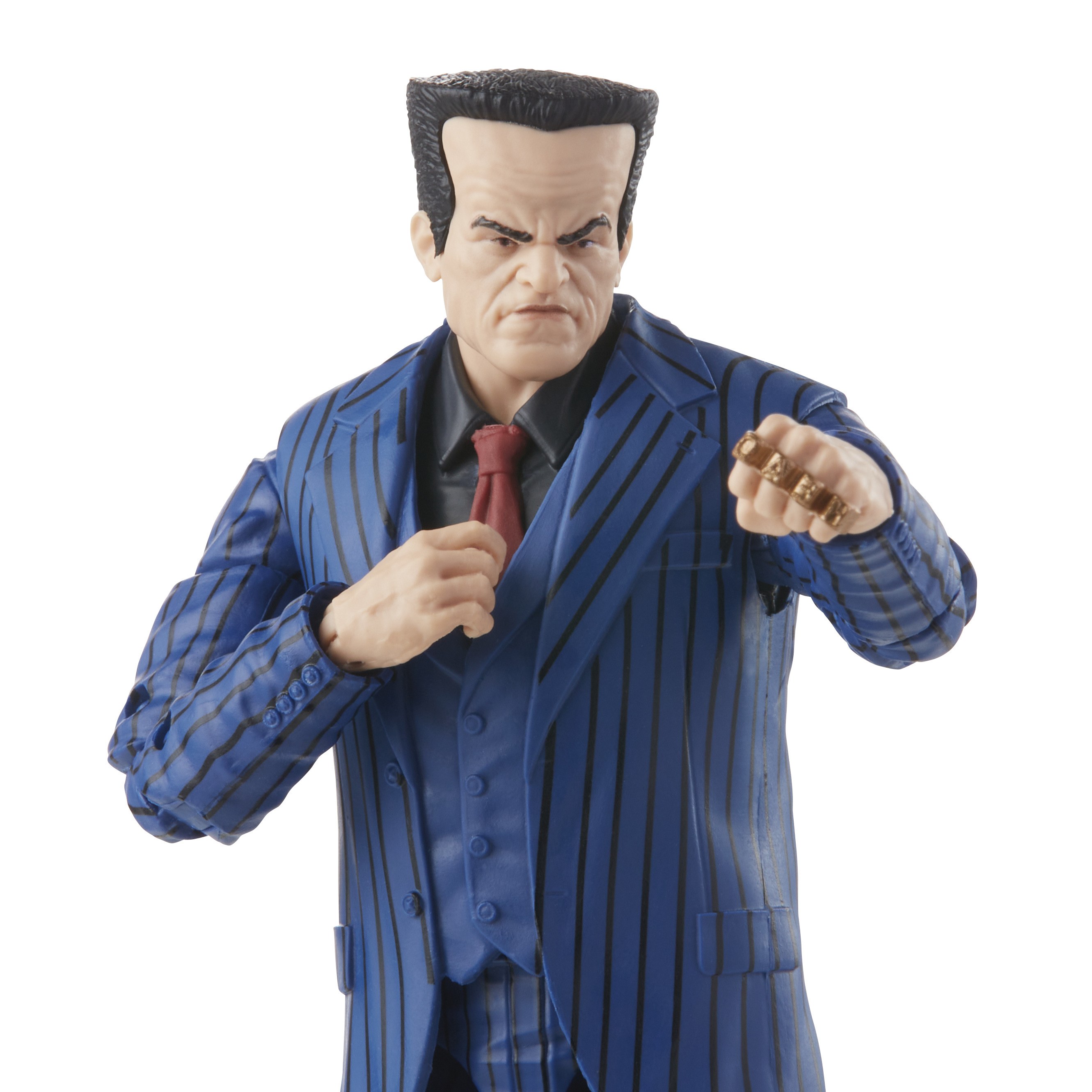 Figurina di un uomo in abito blu, con volto severo e mano ornata di anelli.