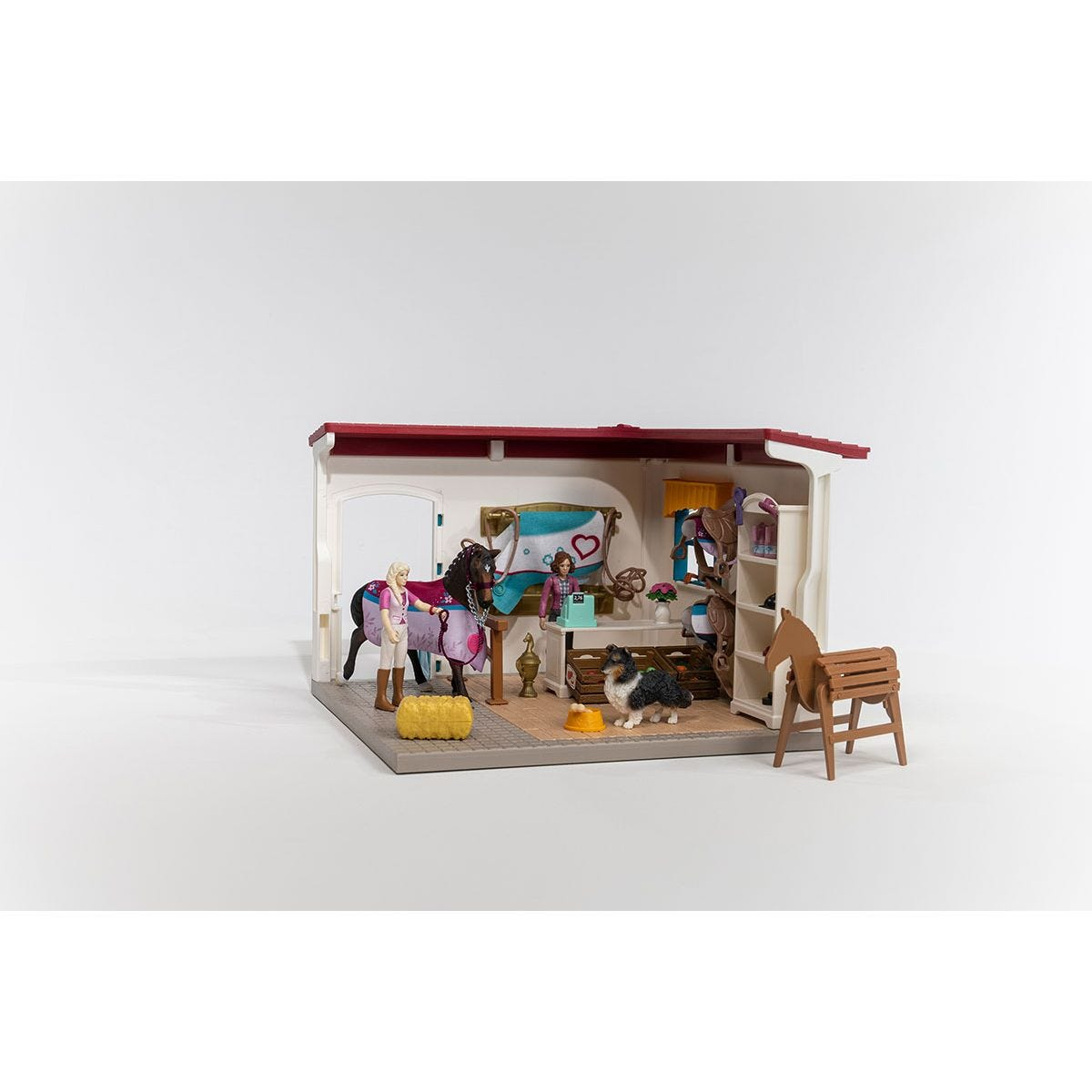 Ein Pferdestall-Spielset mit Pferd, Figur und Zubehör.