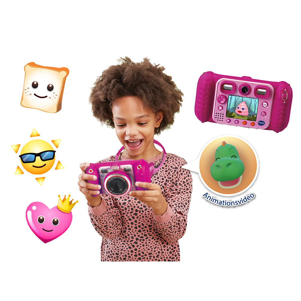 Ein Mädchen macht Fotos mit einer rosa Spielzeugkamera, umgeben von Emoji-Aufklebern. Ein grüner Dinosaurier erscheint auf dem Bildschirm.