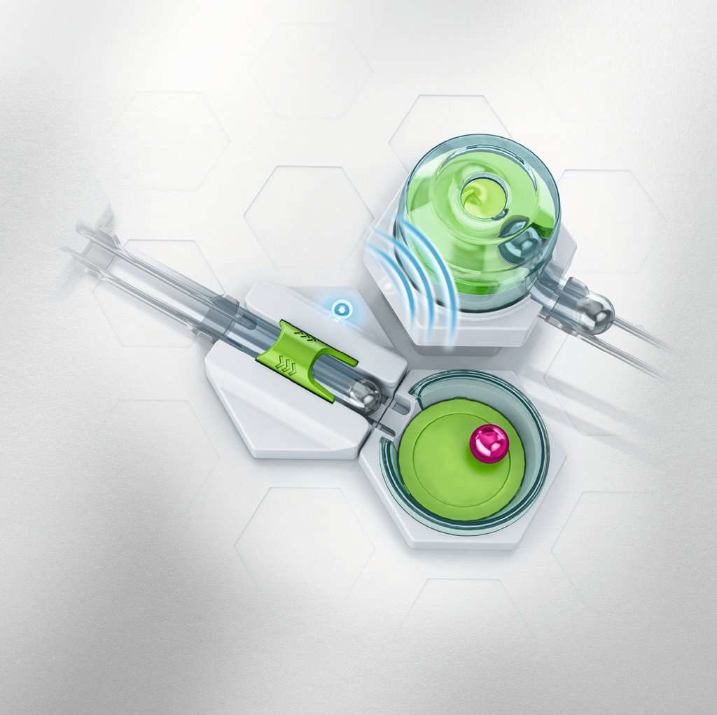 Zabawka z torem kulkowym z zielonymi i pomarańczowymi torami oraz wieloma sześciokątnymi podstawami.