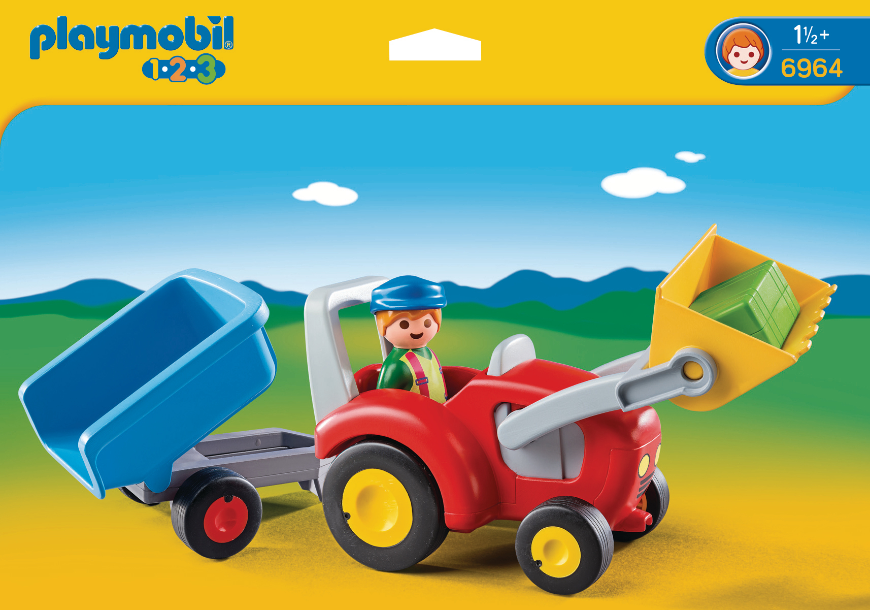 Ein Playmobil-Traktor mit einem Bauern, einem Anhänger und einem Frontlader mit grünen Blöcken.