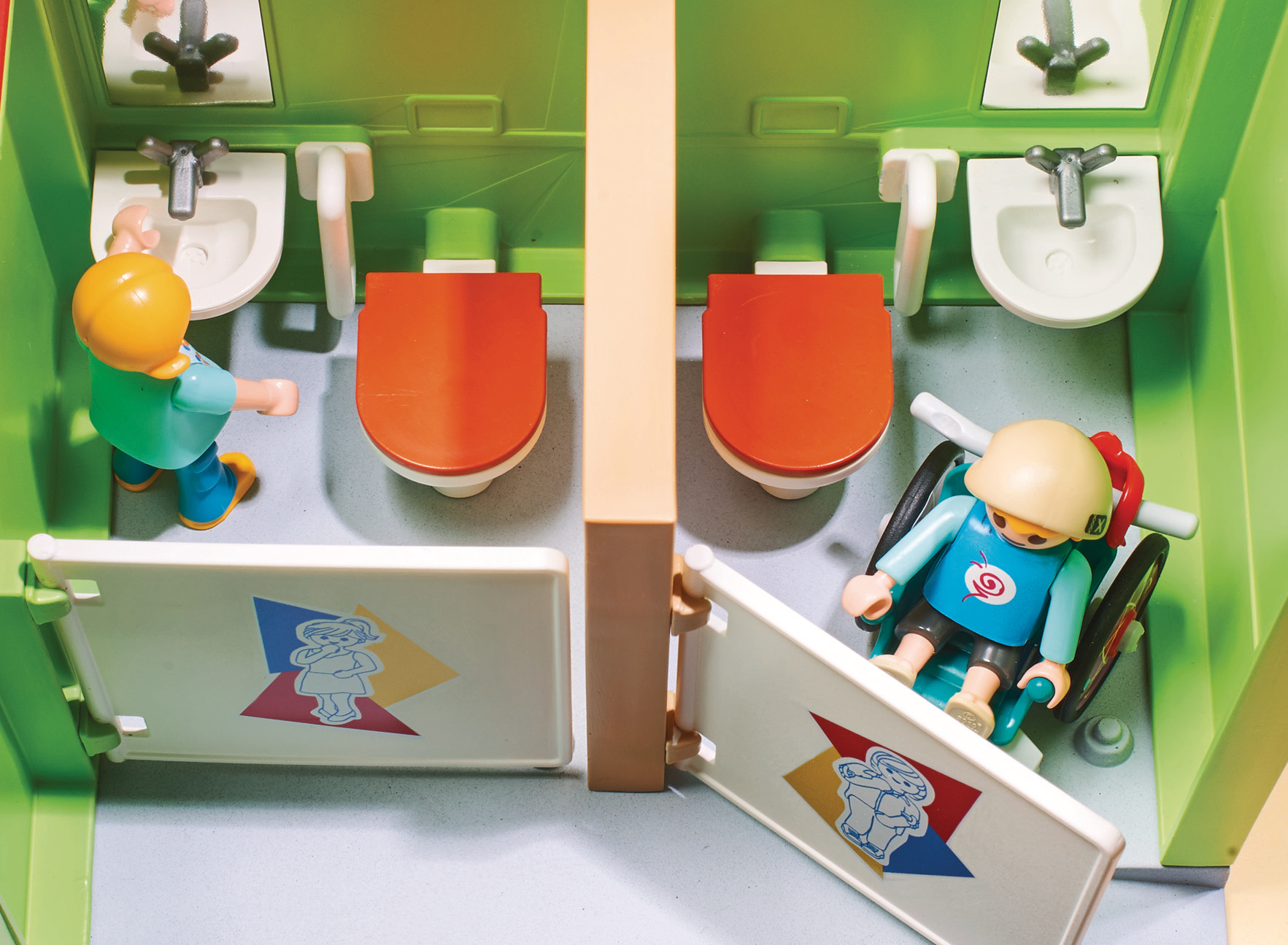 Scena del bagno pubblico Playmobil con servizi igienici e lavandini.