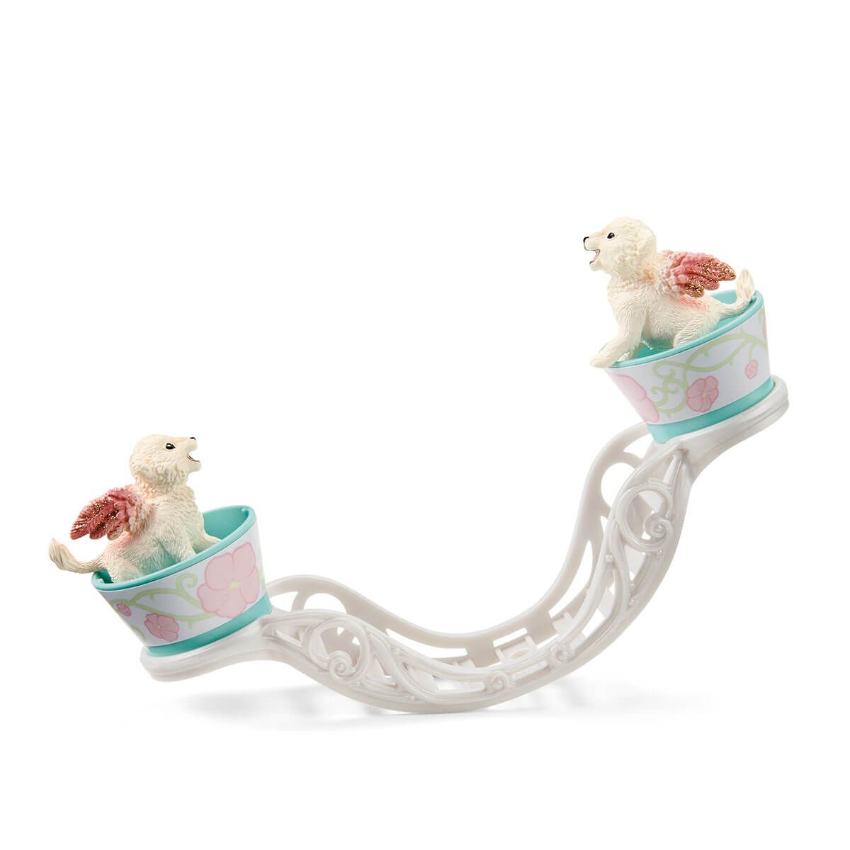 Due cuccioli giocattolo con le ali su una pista bianca con decorazioni floreali rosa e blu.